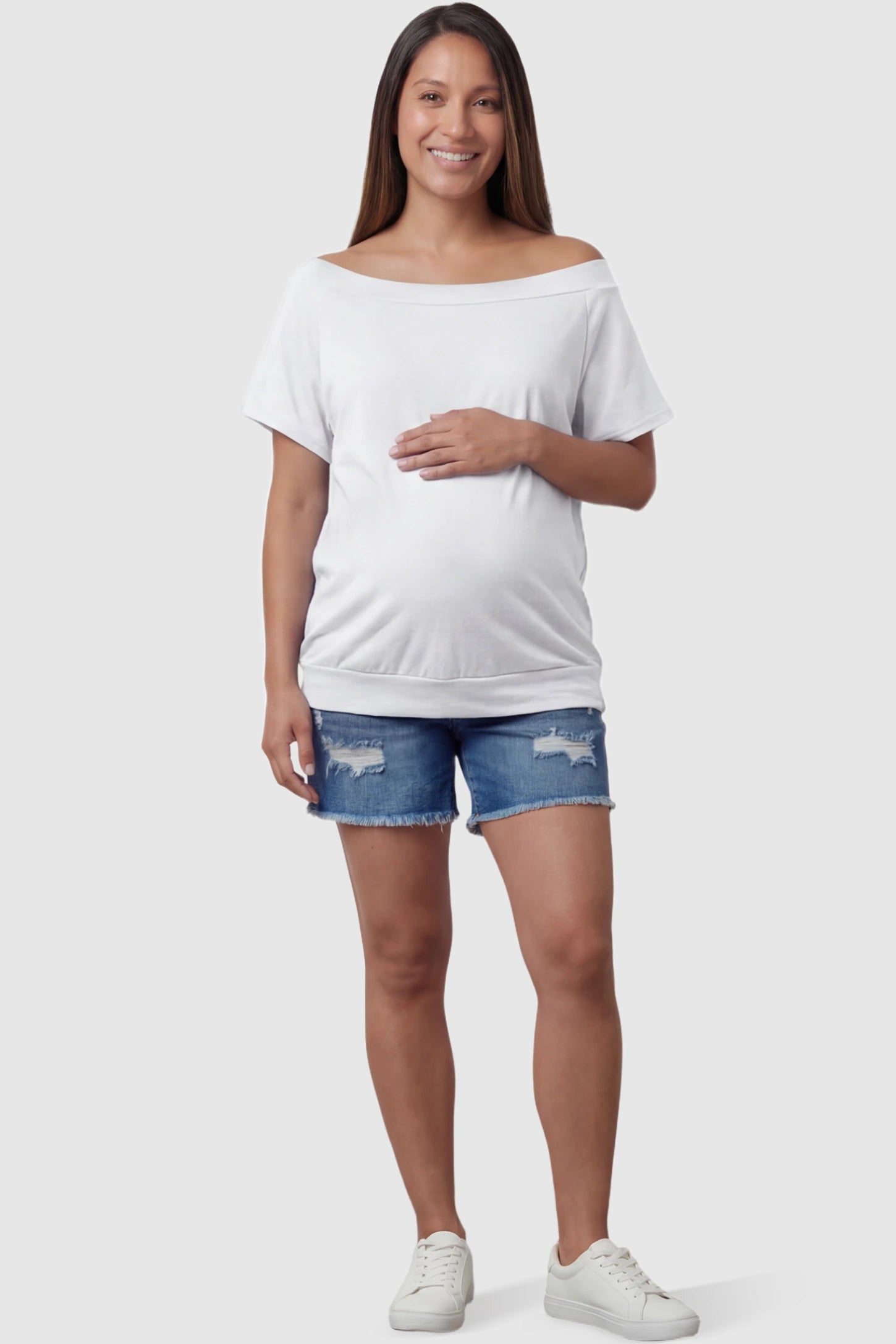 Convertible Neck Short Sleeve Maternity Top Convertible Neck Short Sleeve Maternity Top in white featuring an adjustable neckline and a comfortable banded hem on a pregnant model full body view.