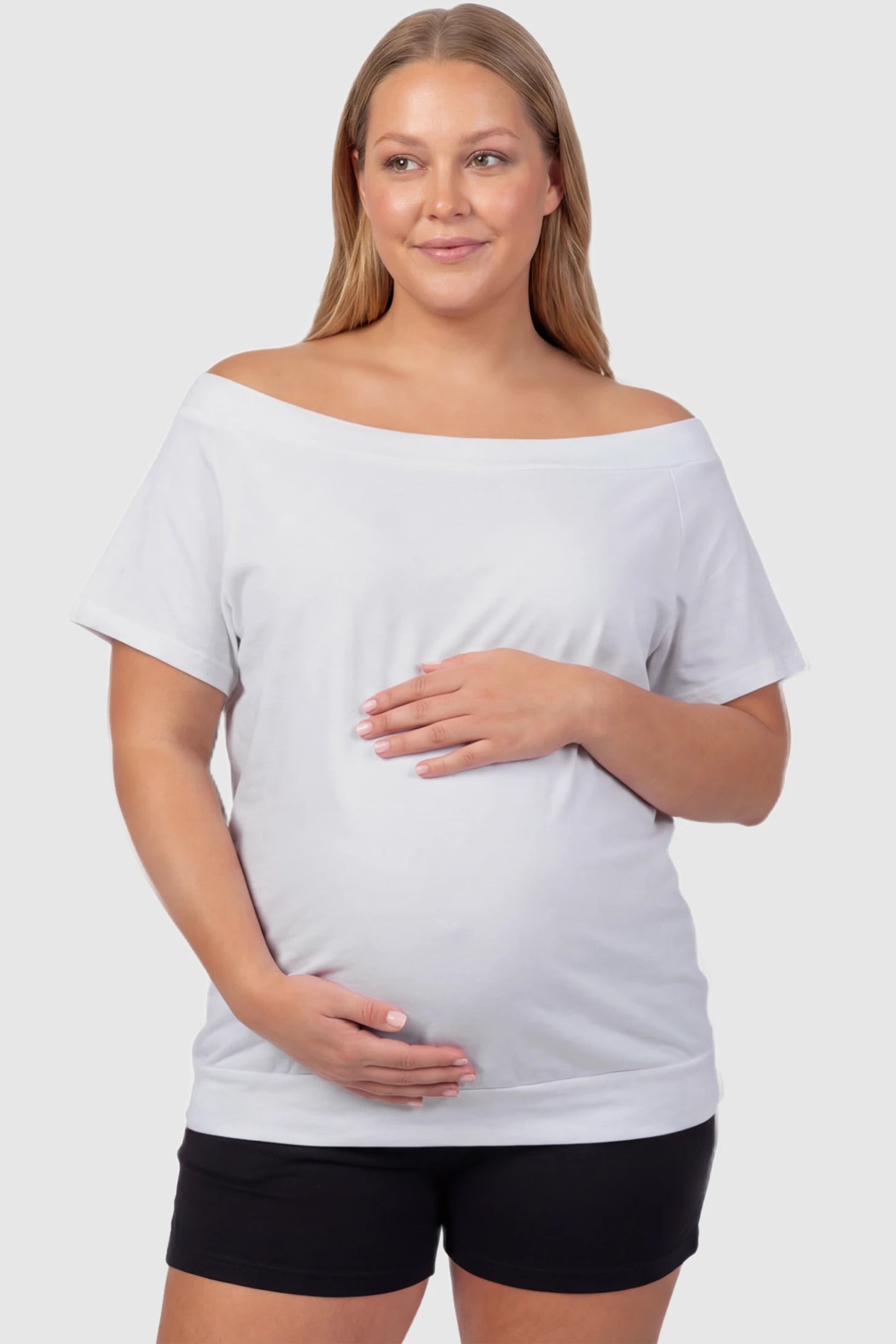 Convertible Neck Short Sleeve Maternity Top Convertible Neck Short Sleeve Maternity Top in white featuring an adjustable neckline and a comfortable banded hem on a plus size pregnant model front view.