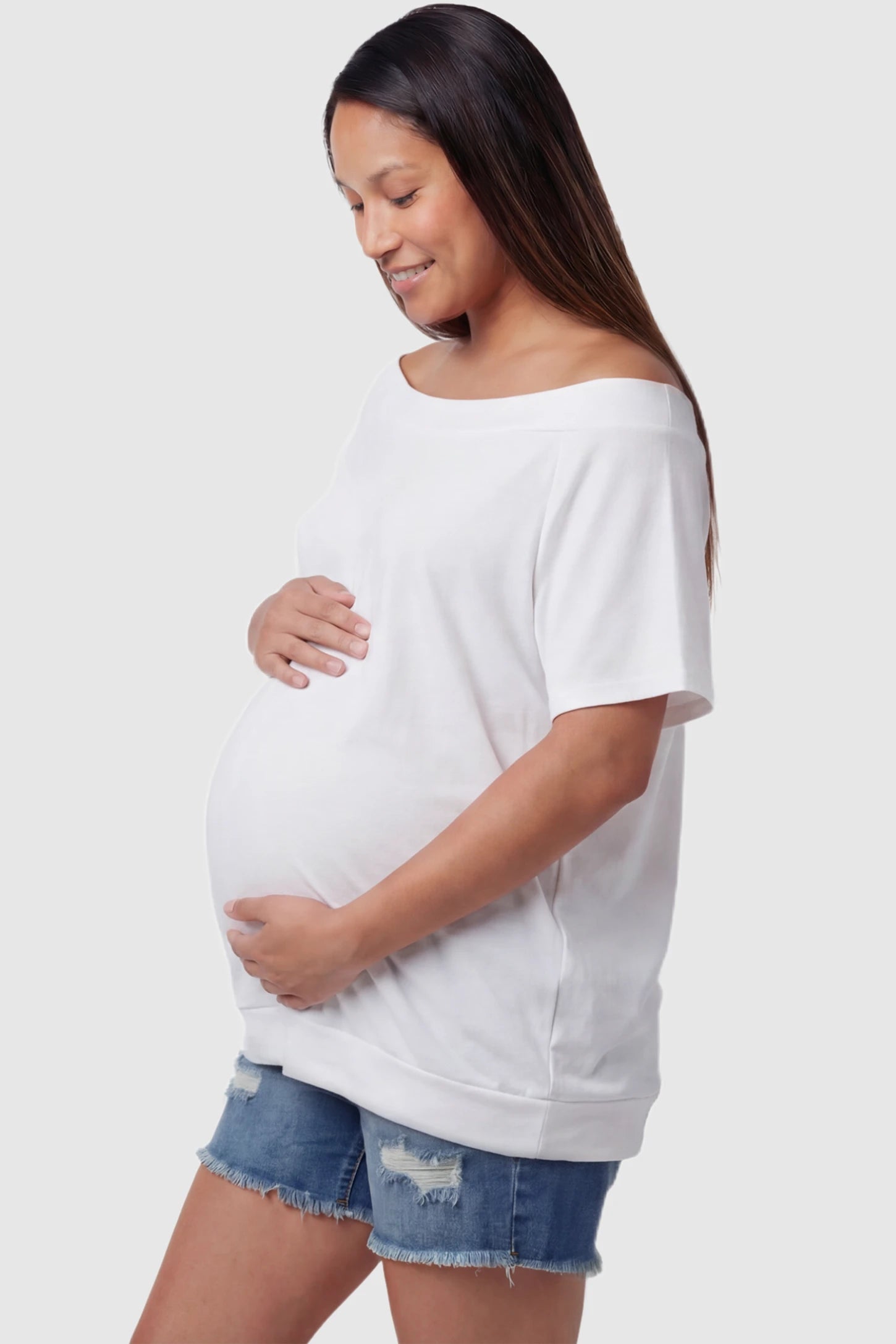 Convertible Neck Short Sleeve Maternity Top Convertible Neck Short Sleeve Maternity Top in white featuring an adjustable neckline and a comfortable banded hem on a pregnant model side view.
