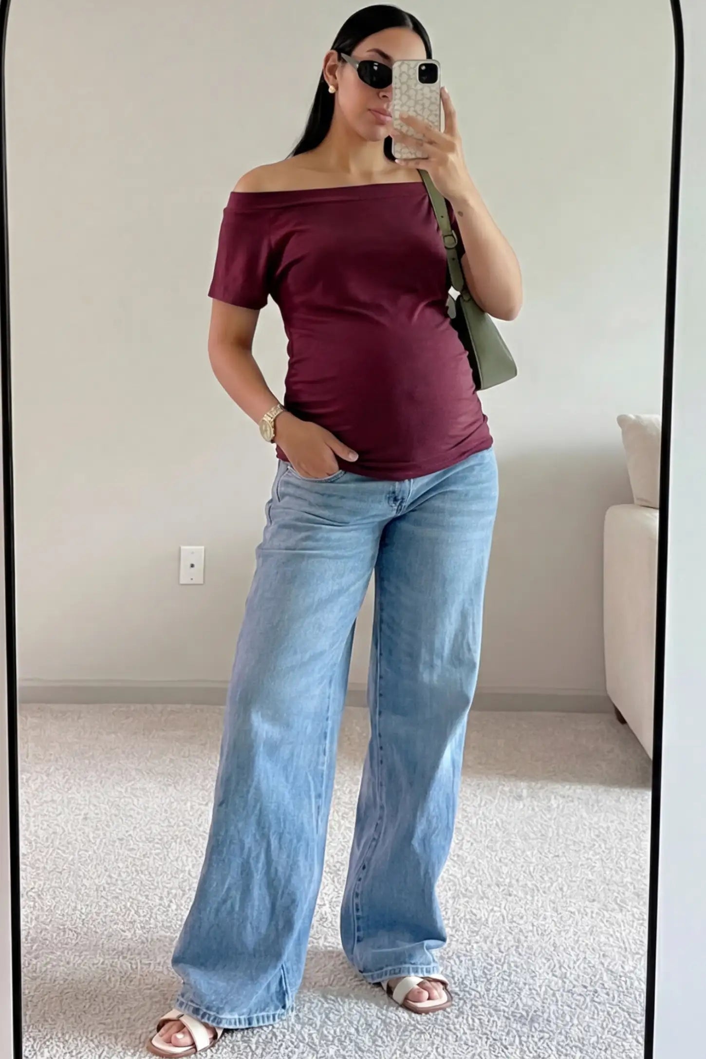 Convertible Neck Short Sleeve Maternity Top Convertible Neck Short Sleeve Maternity Top in wine red featuring an adjustable neckline and a comfortable banded hem paired with blue jeans worn by a pregnant woman in an indoor setting front view.