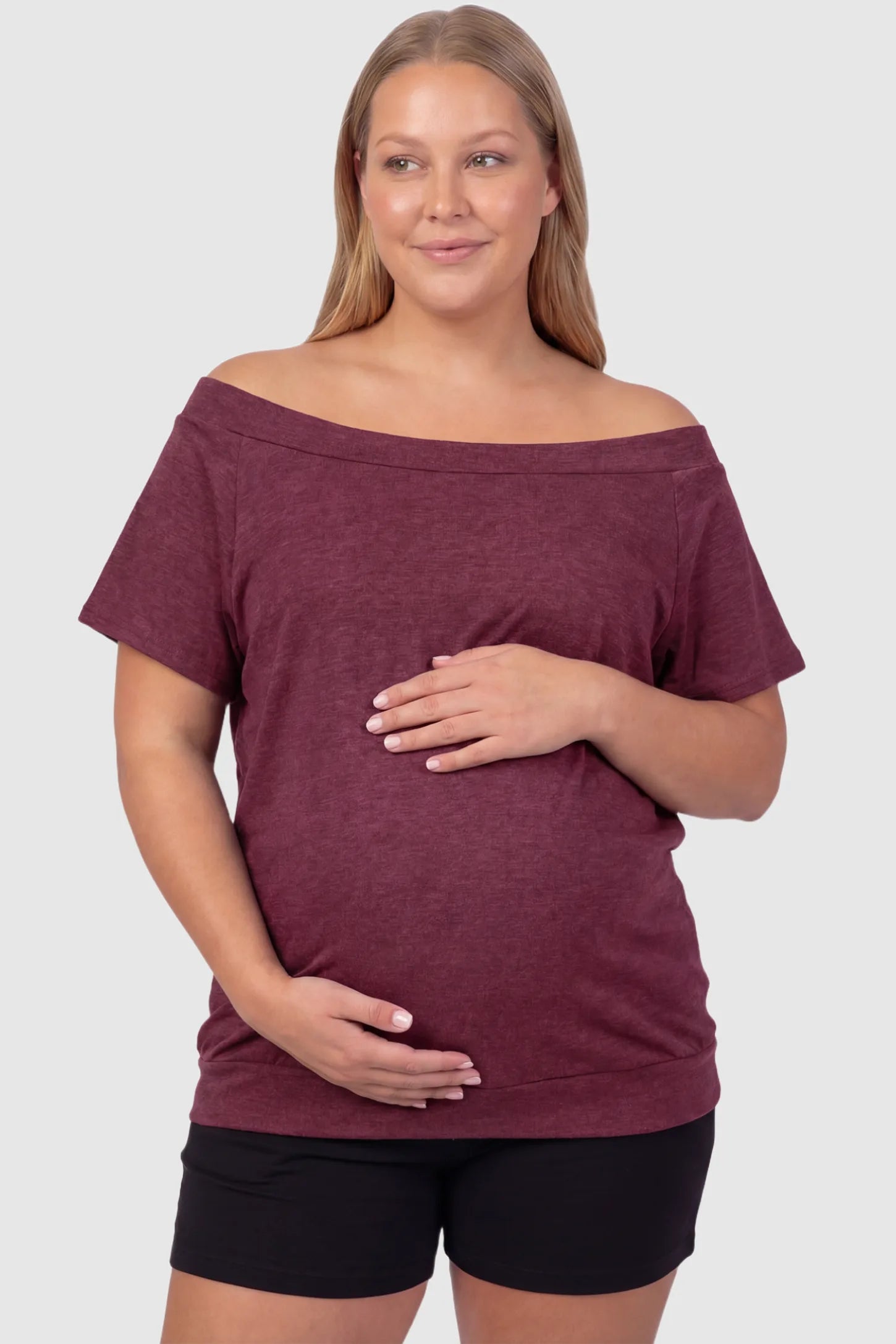 Convertible Neck Short Sleeve Maternity Top Convertible Neck Short Sleeve Maternity Top in wine red featuring an adjustable neckline and a comfortable banded hem on a plus size pregnant model front view.