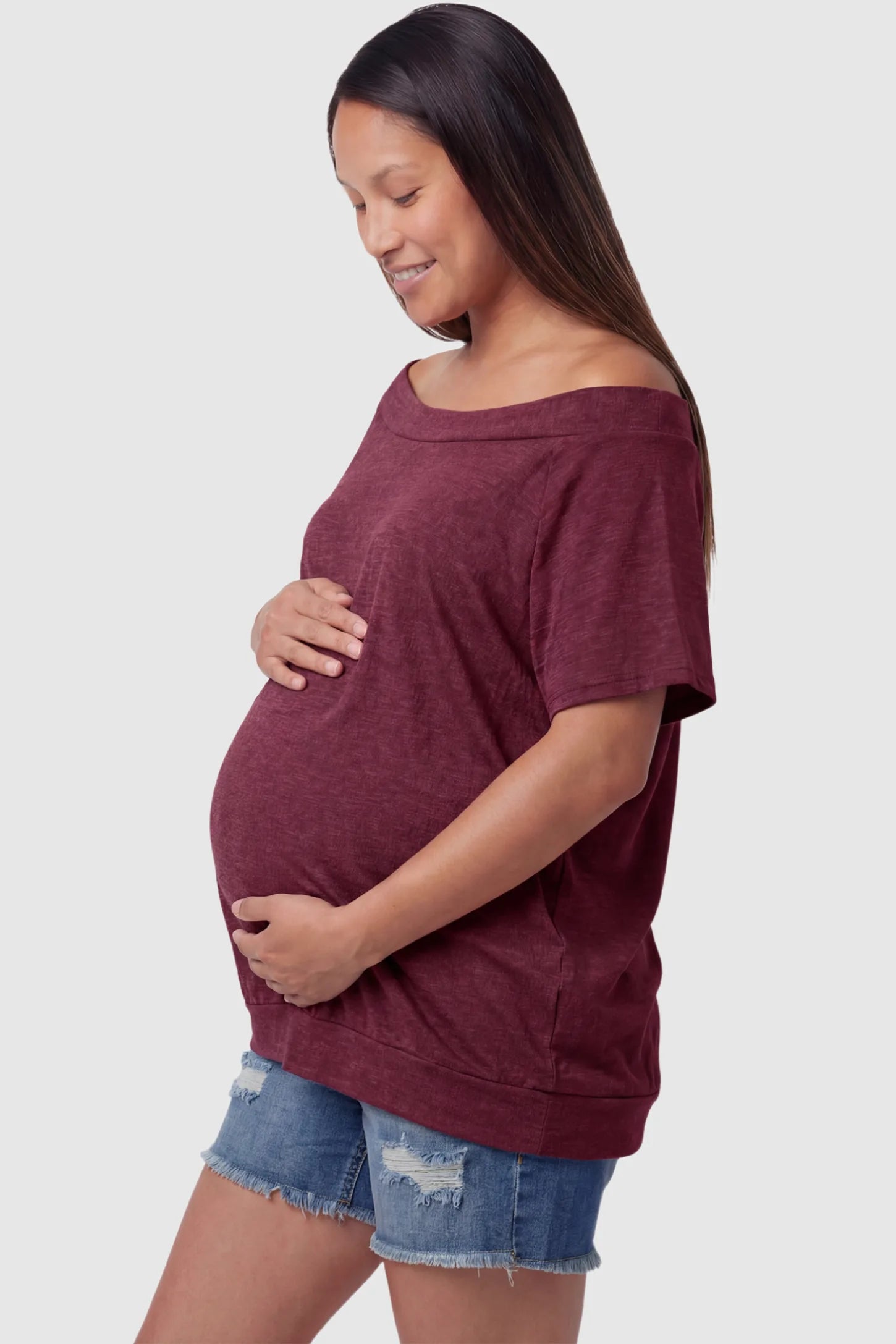 Convertible Neck Short Sleeve Maternity Top Convertible Neck Short Sleeve Maternity Top in wine red featuring an adjustable neckline and a comfortable banded hem on a pregnant model side view.