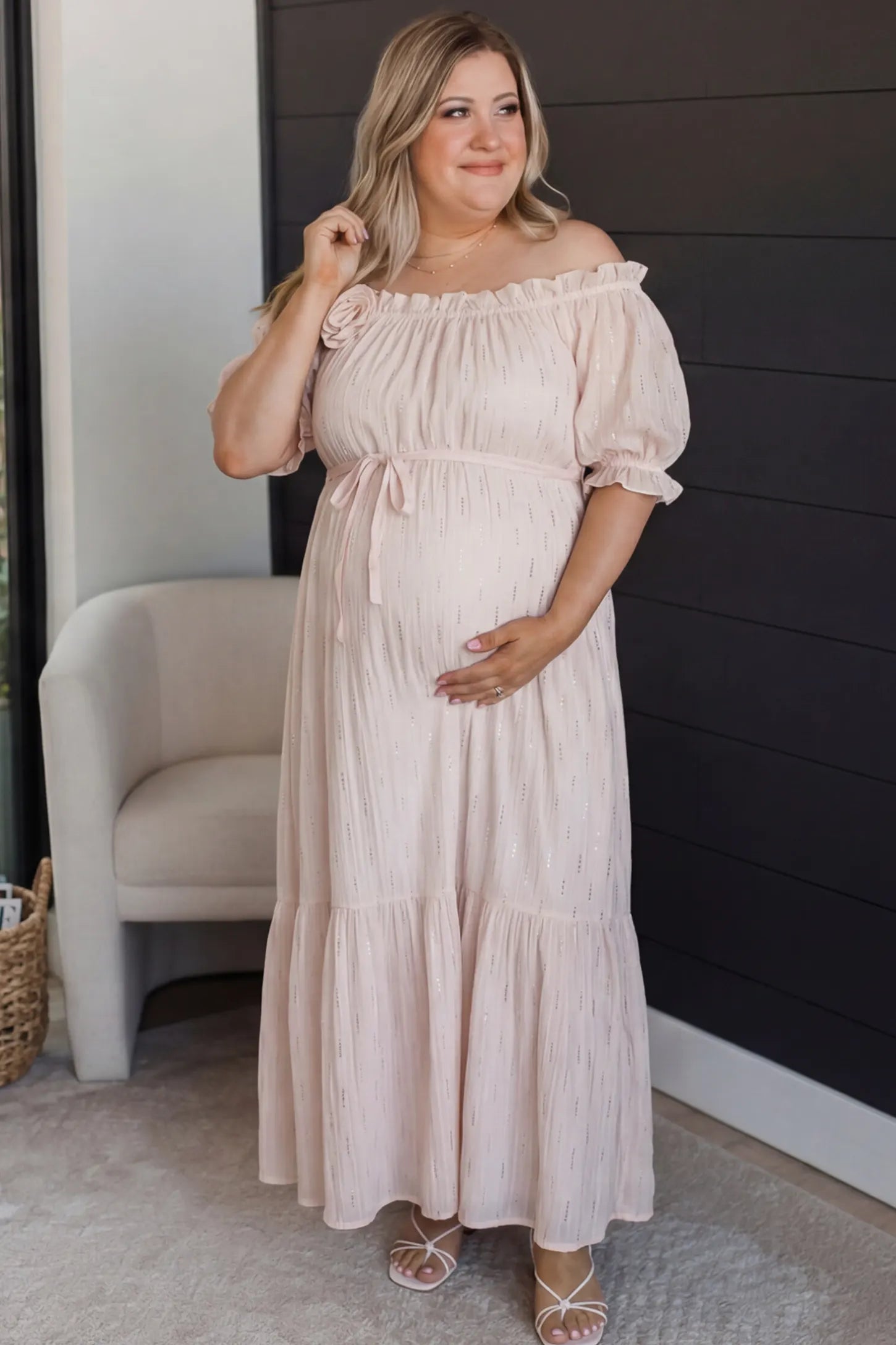 Convertible Neck Tiered Maternity Midi Dress Convertible Neck Tiered Maternity Midi Dress in Pink featuring elastic waist tie, short sleeves on a pregnant woman in indoor setting, front view.