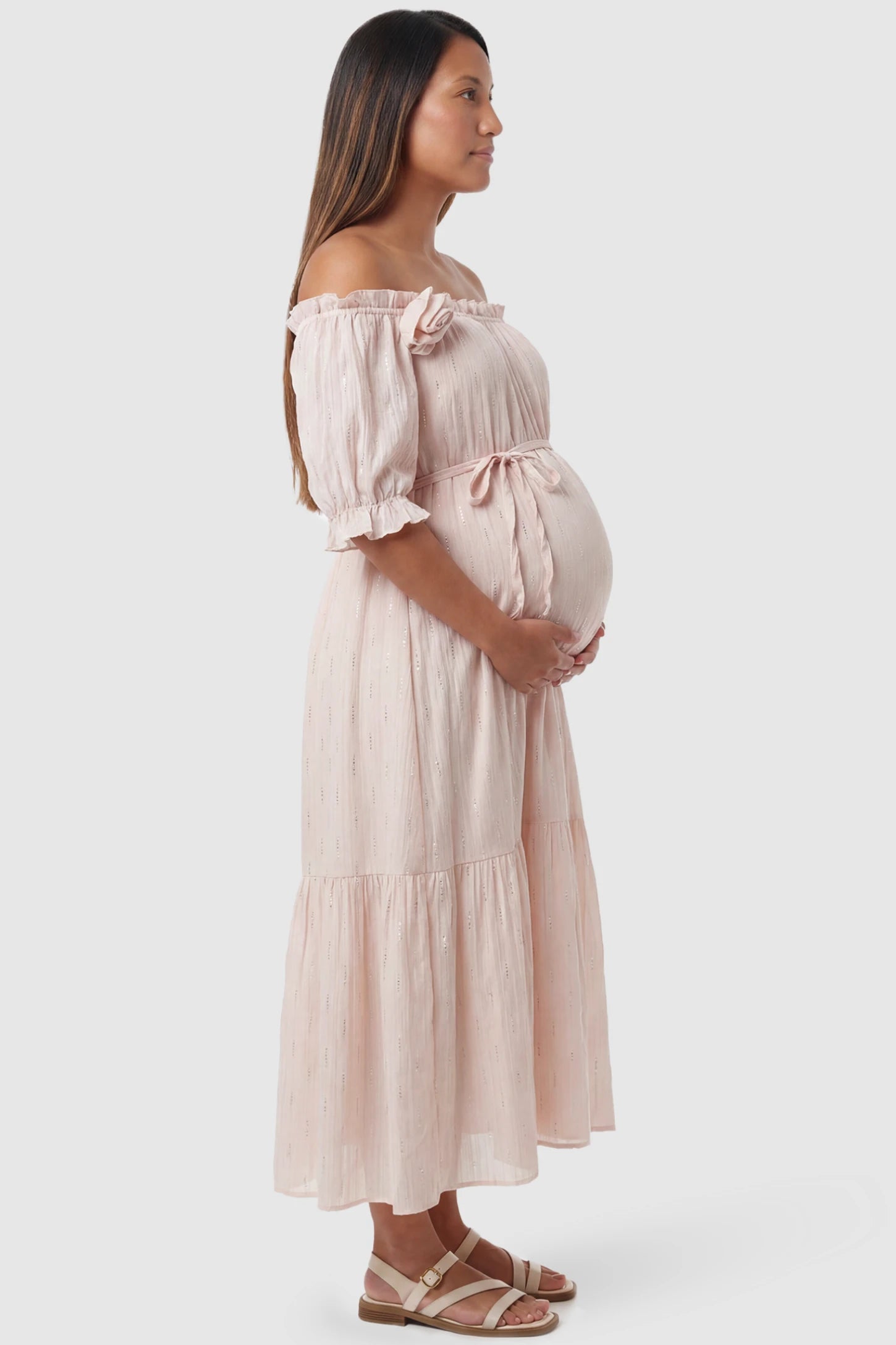 Convertible Neck Tiered Maternity Midi Dress Convertible Neck Tiered Maternity Midi Dress in Pink featuring elastic waist tie, short sleeves on a pregnant model, side view.
