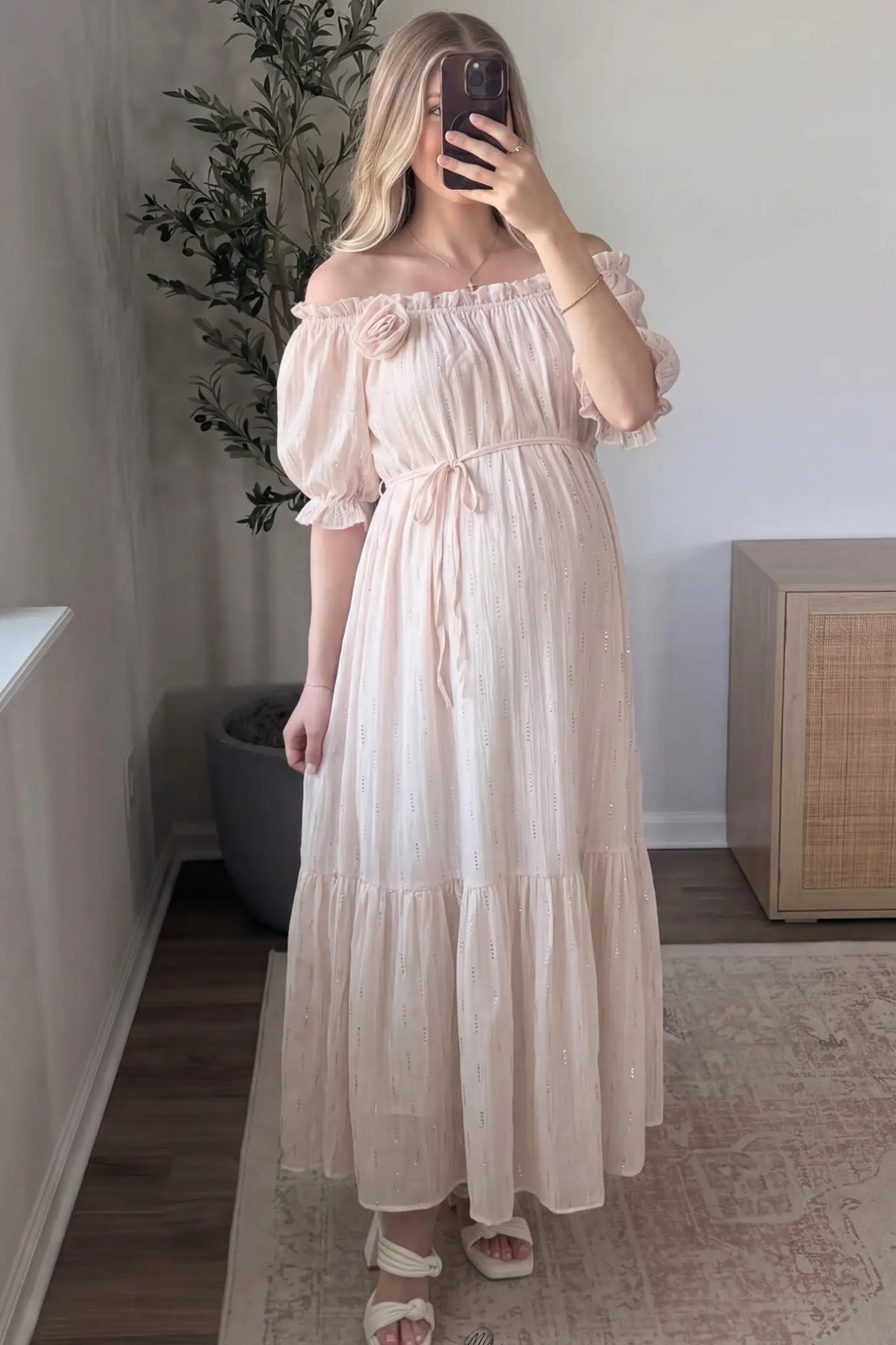 Convertible Neck Tiered Maternity Midi Dress Convertible Neck Tiered Maternity Midi Dress in Pink featuring elastic waist tie, short sleeves on a pregnant woman in indoor setting, front view.