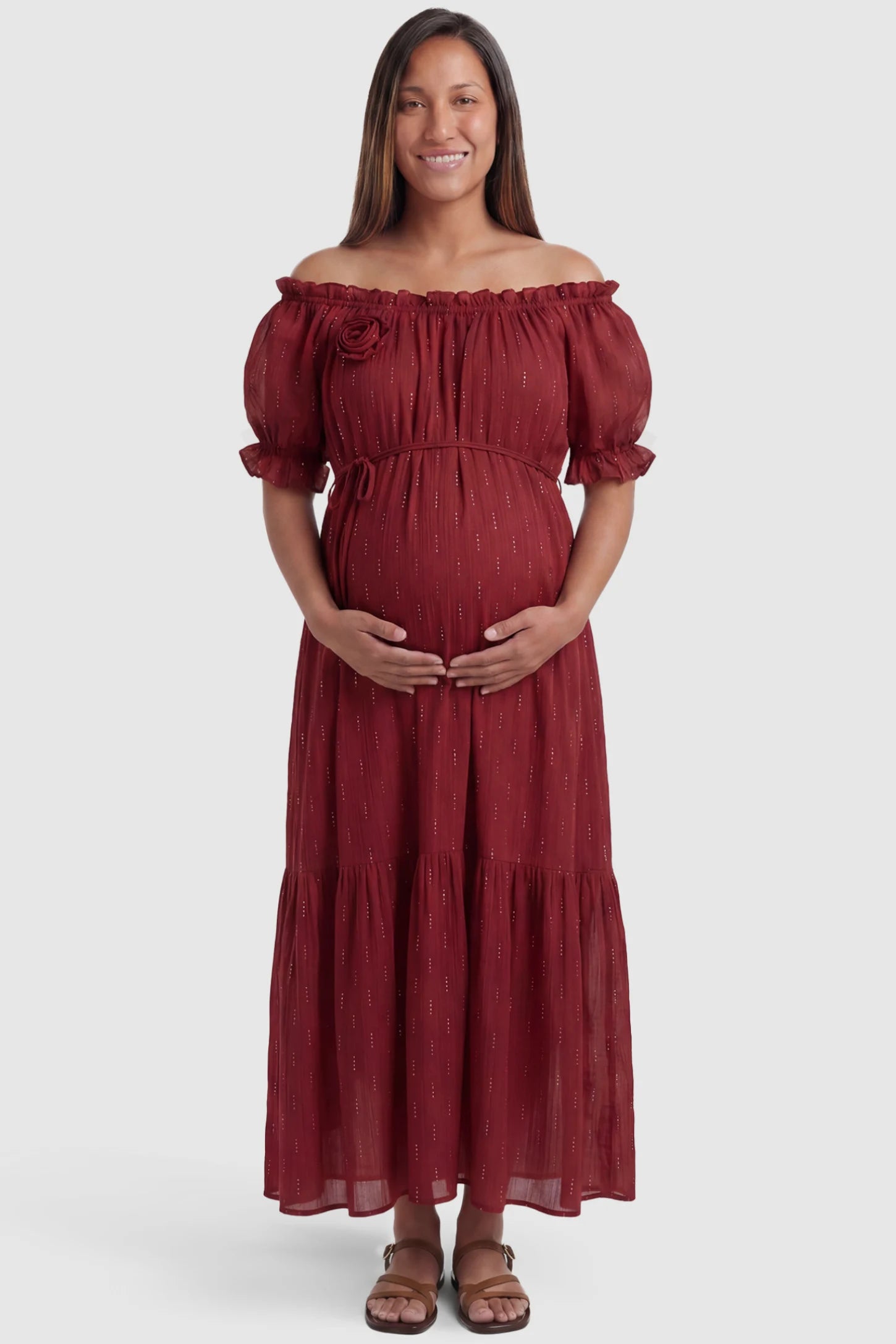 Convertible Neck Tiered Maternity Midi Dress Convertible Neck Tiered Maternity Midi Dress in Red featuring elastic waist tie, short sleeves on a pregnant model, front view.