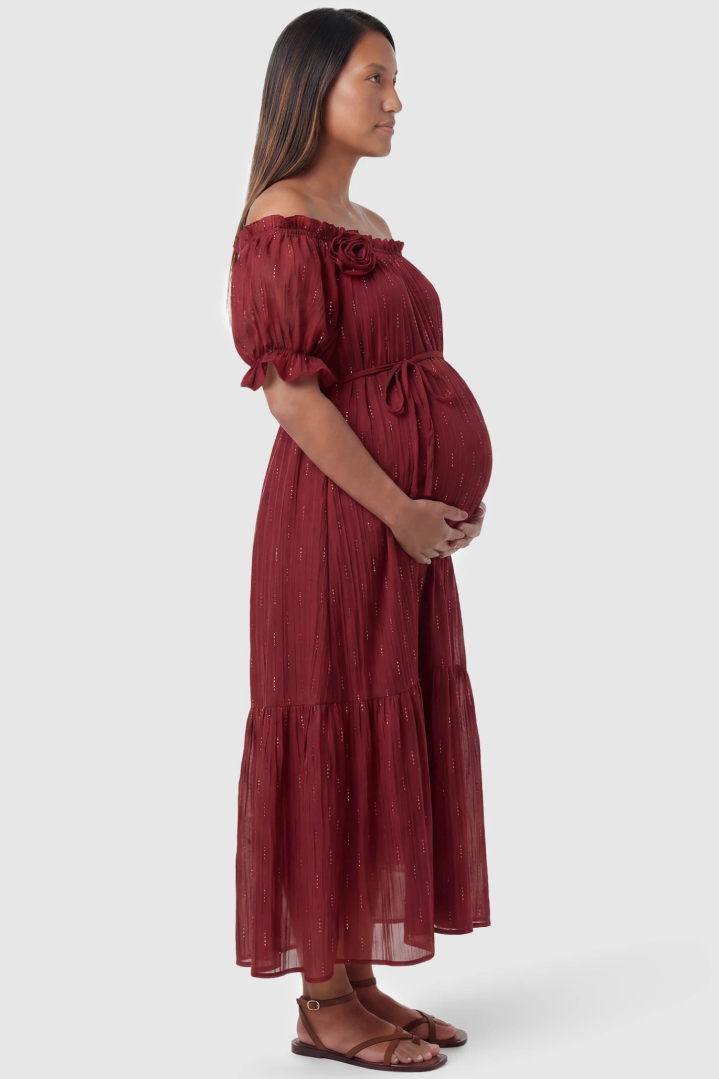 Convertible Neck Tiered Maternity Midi Dress Convertible Neck Tiered Maternity Midi Dress in Red featuring elastic waist tie, short sleeves on a pregnant model, side view.
