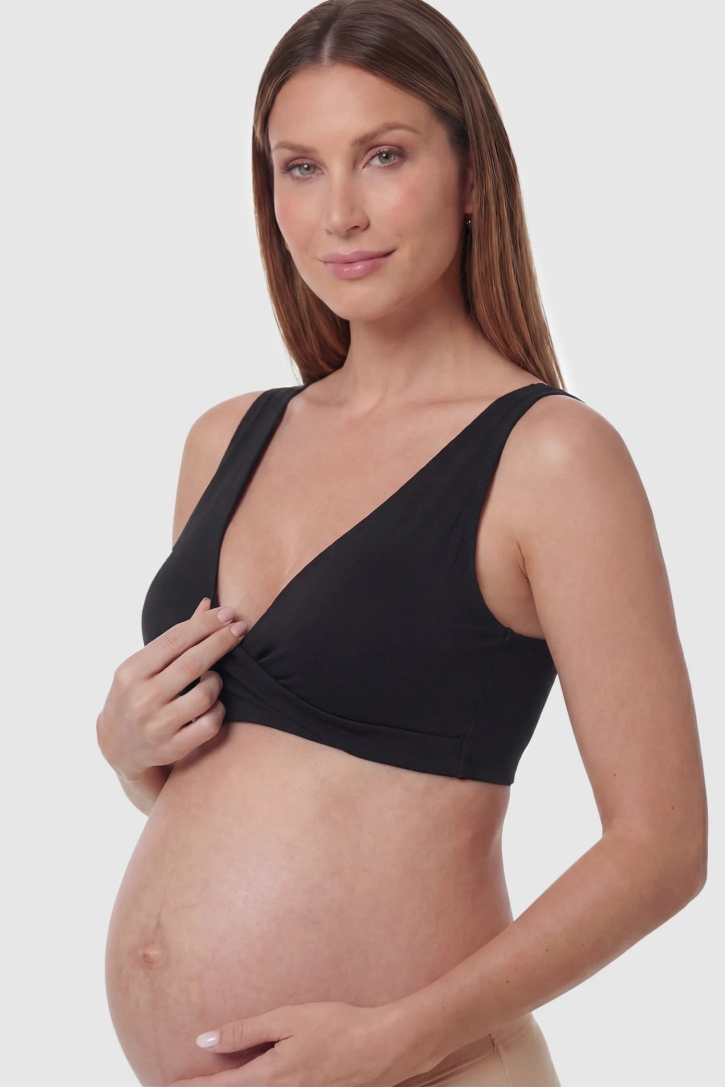 Cotton Blend Crossover Maternity Nursing Bra Cotton Blend Crossover Maternity Nursing Bra in Black featuring a wire-free wrap front on a pregnant model showing detail.