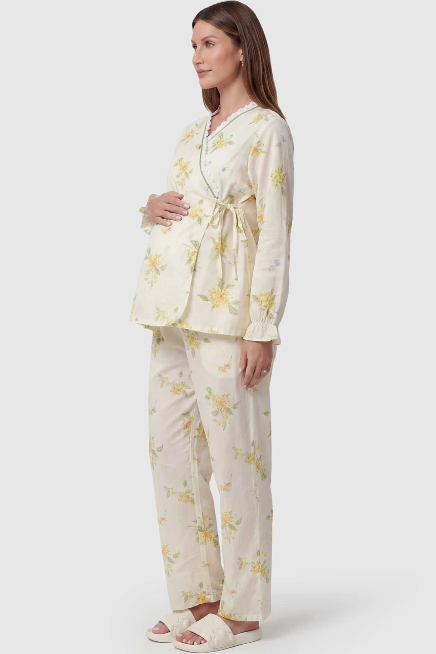 Cotton Long Sleeve Top & Pants Maternity Pajama Set Cotton Long Sleeve Maternity Pajama Set in Osmanthus Floral Print featuring a wrap-style top and lace trim on a pregnant model showing side.