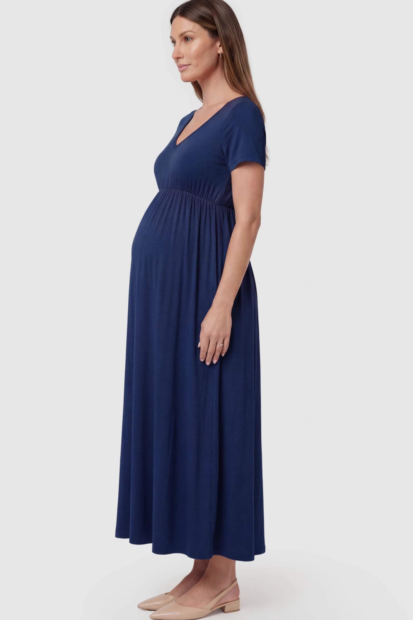 Cotton V-Neck Short Sleeve Maternity Maxi Dress Solid V-Neck Maxi Maternity Dress in Blue featuring breathable cotton and a deep neckline on a pregnant model showing side.
