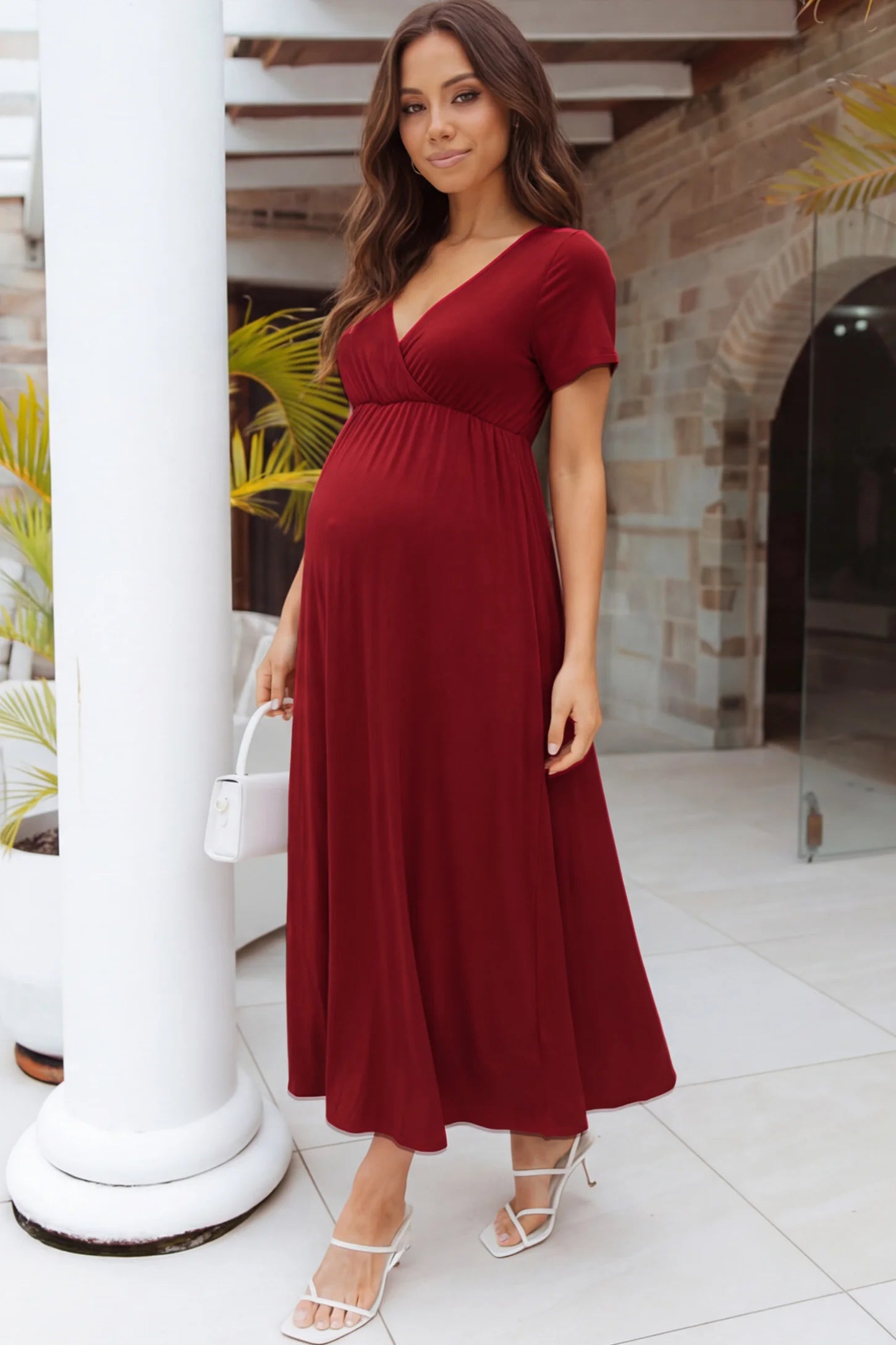Cotton V-Neck Short Sleeve Maternity Maxi Dress Solid V-Neck Maxi Maternity Dress in Dark red featuring breathable cotton and a deep neckline on a pregnant woman showing front.