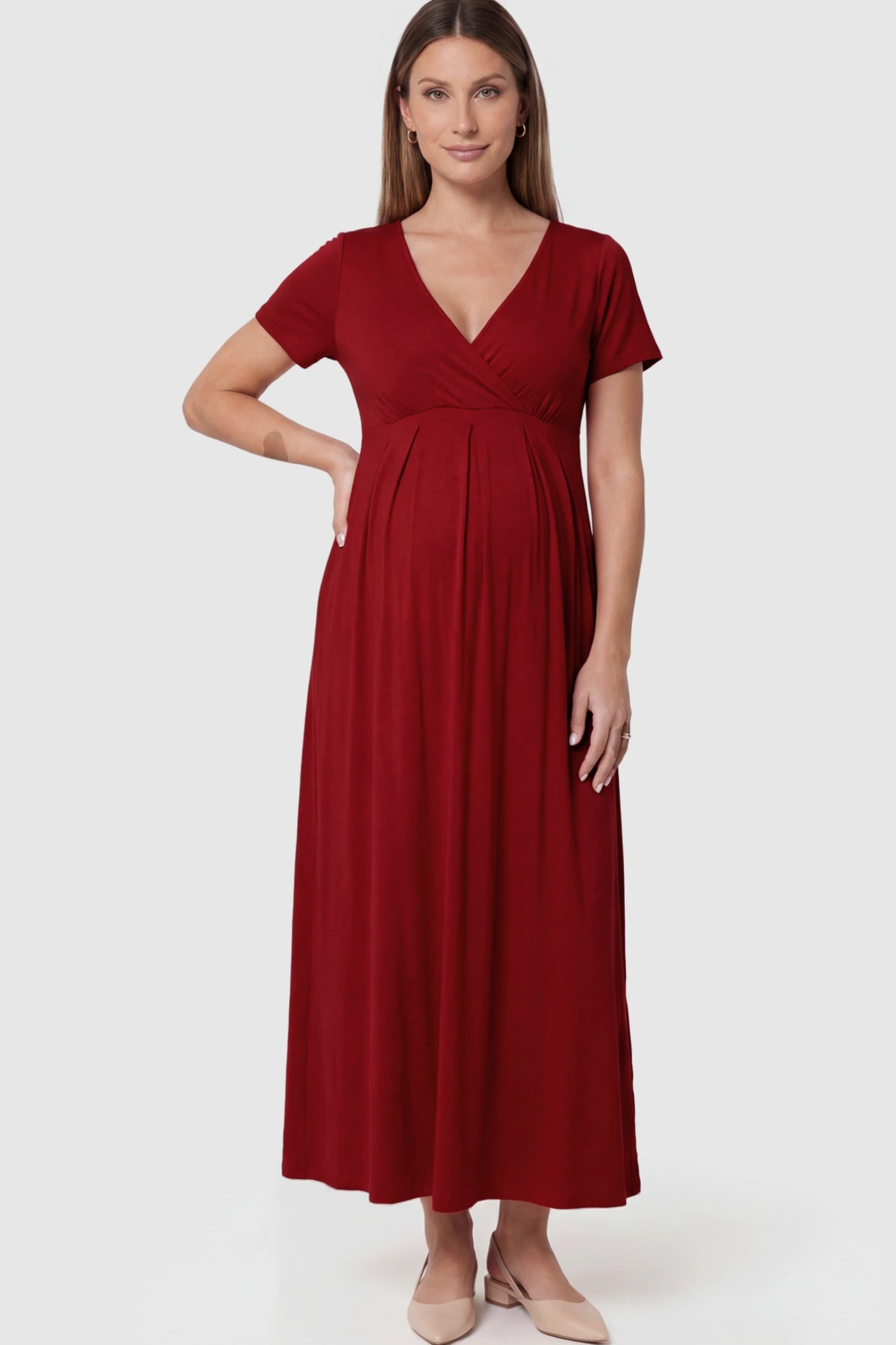 Cotton V-Neck Short Sleeve Maternity Maxi Dress Solid V-Neck Maxi Maternity Dress in dark red featuring breathable cotton and a deep neckline on a pregnant model showing front.