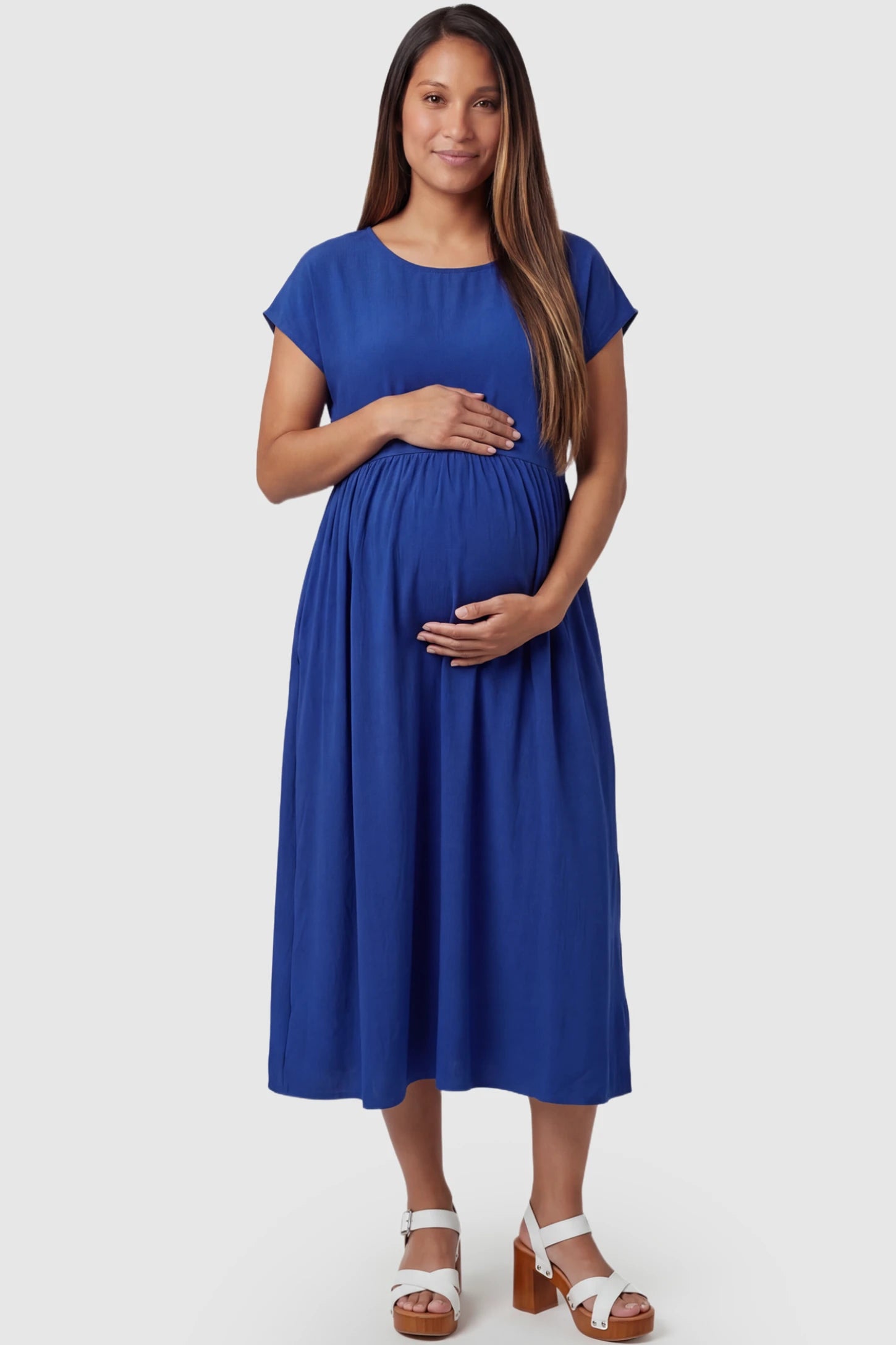 Crew Neck Short Sleeve Maternity Midi Dress Crew Neck Short Sleeve Maternity Midi Dress in Blue featuring a flowy shift silhouette on a pregnant model, front view.