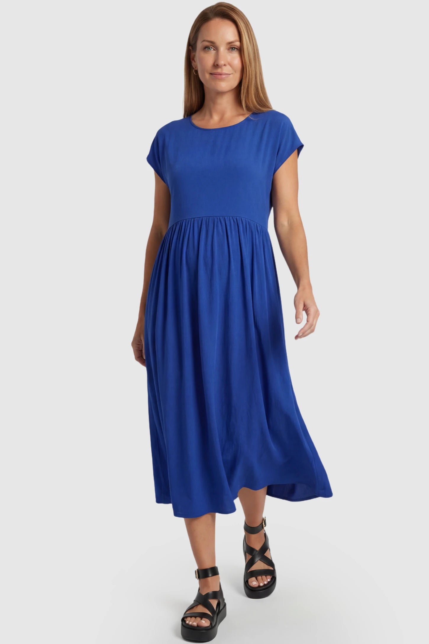 Crew Neck Short Sleeve Maternity Midi Dress Crew Neck Short Sleeve Maternity Midi Dress in Blue featuring a flowy shift silhouette on a postpartum model, front view.