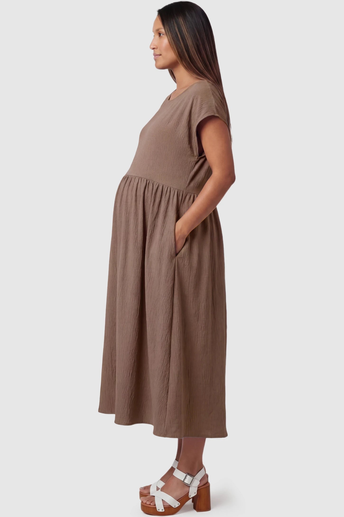 Crew Neck Short Sleeve Maternity Midi Dress Crew Neck Short Sleeve Maternity Midi Dress in Khaki featuring a flowy shift silhouette on a pregnant model, side view.