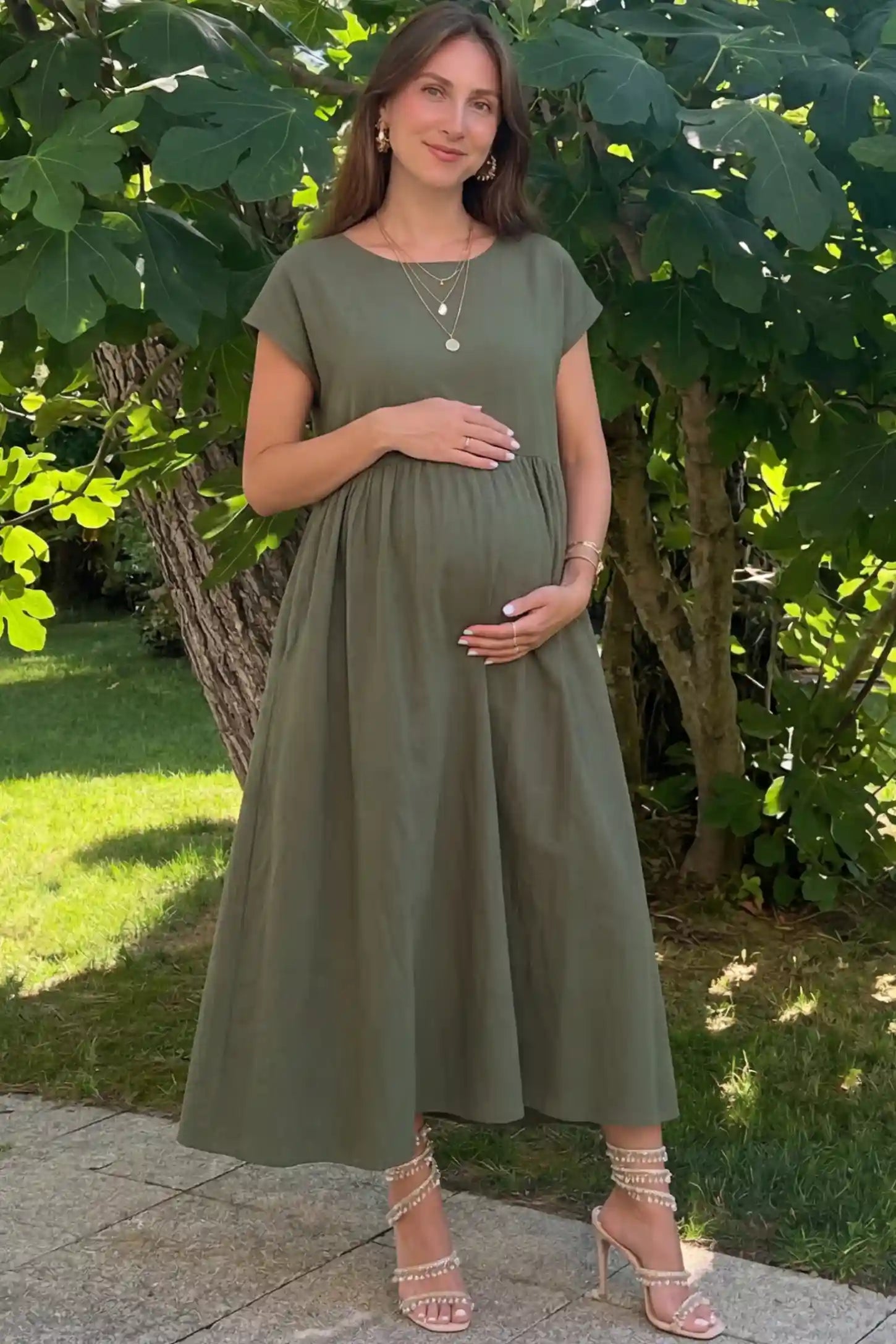 Crew Neck Short Sleeve Maternity Midi Dress Crew Neck Short Sleeve Maternity Midi Dress in Army Green featuring a flowy shift silhouette on a pregnant woman, front view.