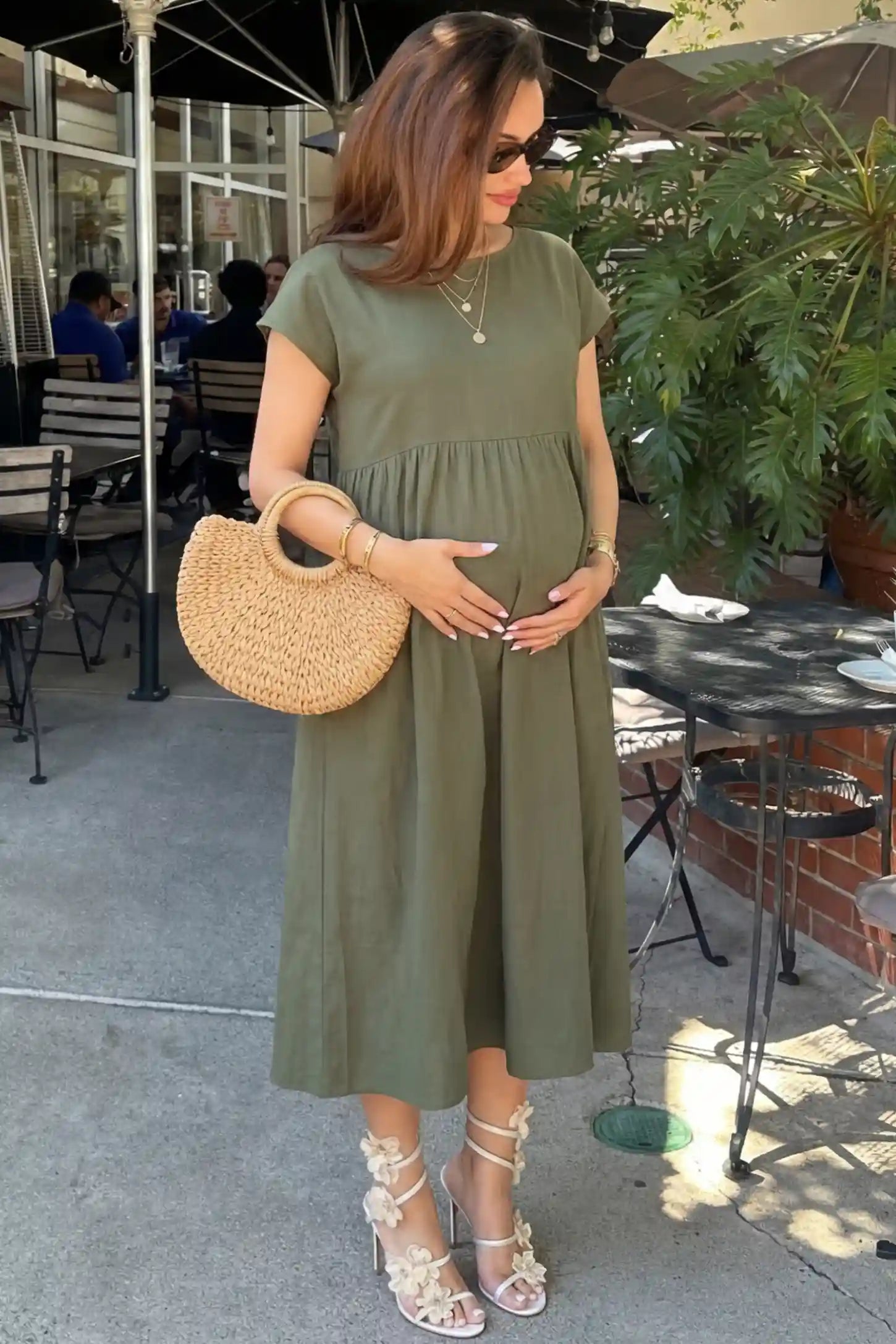 Crew Neck Short Sleeve Maternity Midi Dress Crew Neck Short Sleeve Maternity Midi Dress in Army Green featuring a flowy shift silhouette on a pregnant woman, side view.