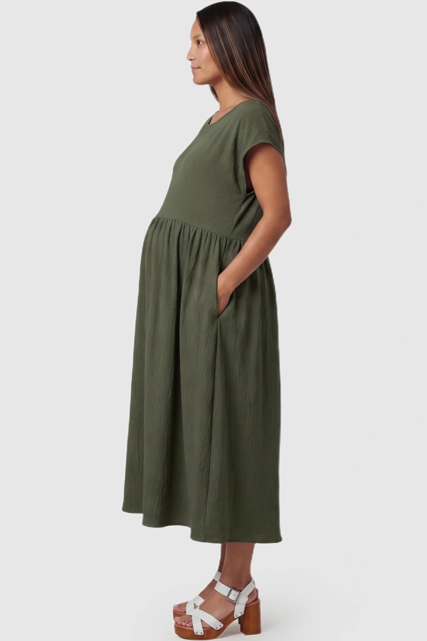 Crew Neck Short Sleeve Maternity Midi Dress Crew Neck Short Sleeve Maternity Midi Dress in Army Green featuring a flowy shift silhouette on a pregnant model, side view.