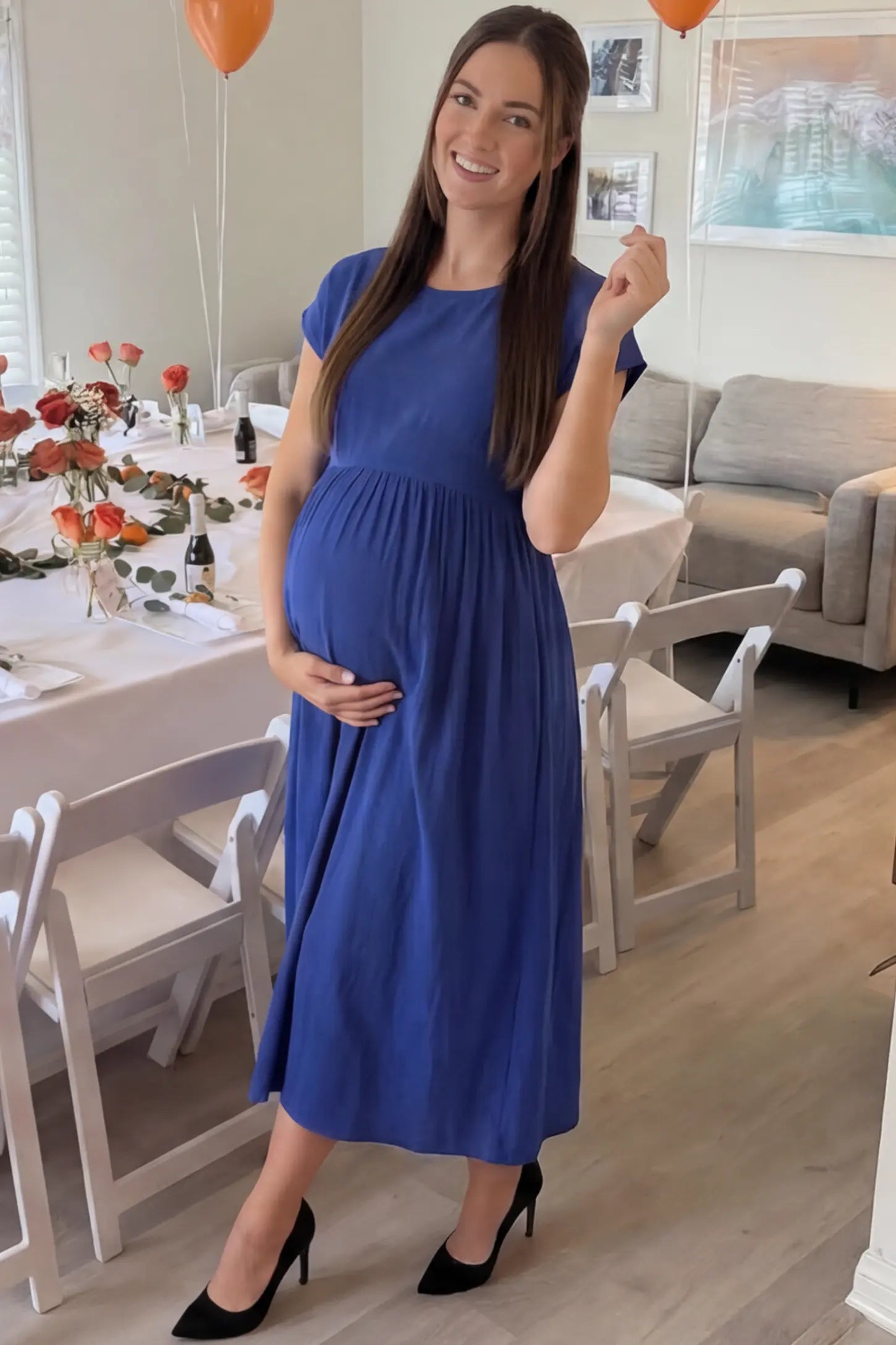 Crew Neck Short Sleeve Maternity Midi Dress Crew Neck Short Sleeve Maternity Midi Dress in Blue featuring a flowy shift silhouette on a pregnant woman, front view.