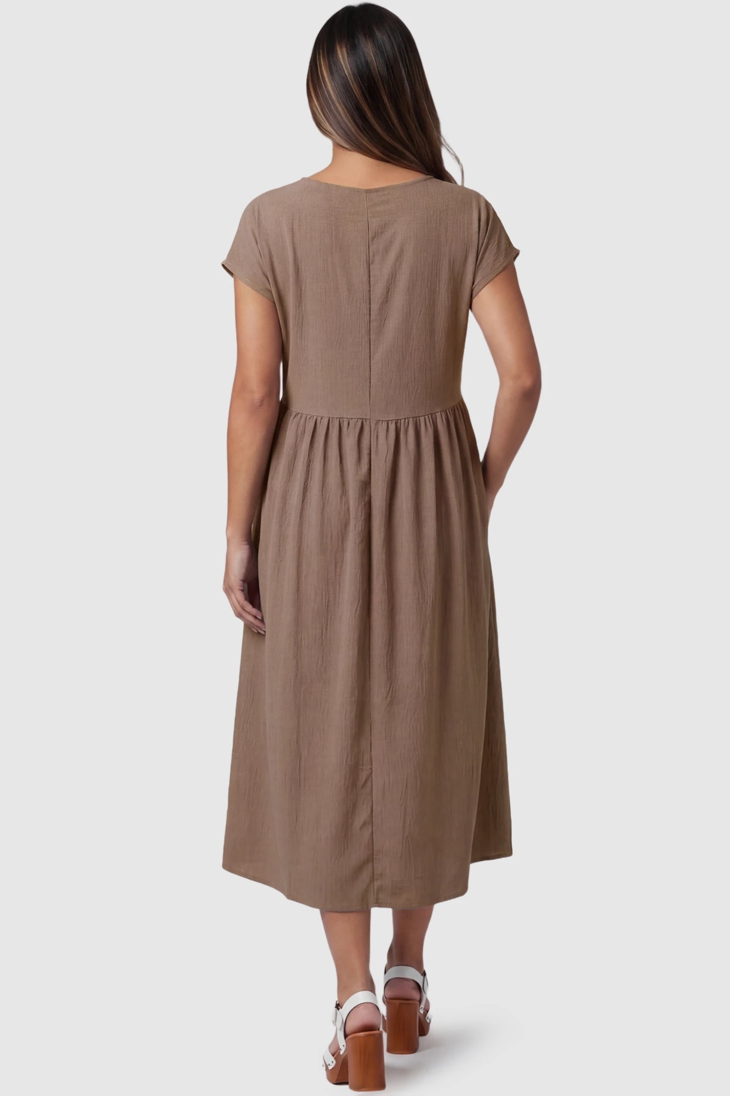 Crew Neck Short Sleeve Maternity Midi Dress Crew Neck Short Sleeve Maternity Midi Dress in Khaki featuring a flowy shift silhouette on a pregnant model, back view.