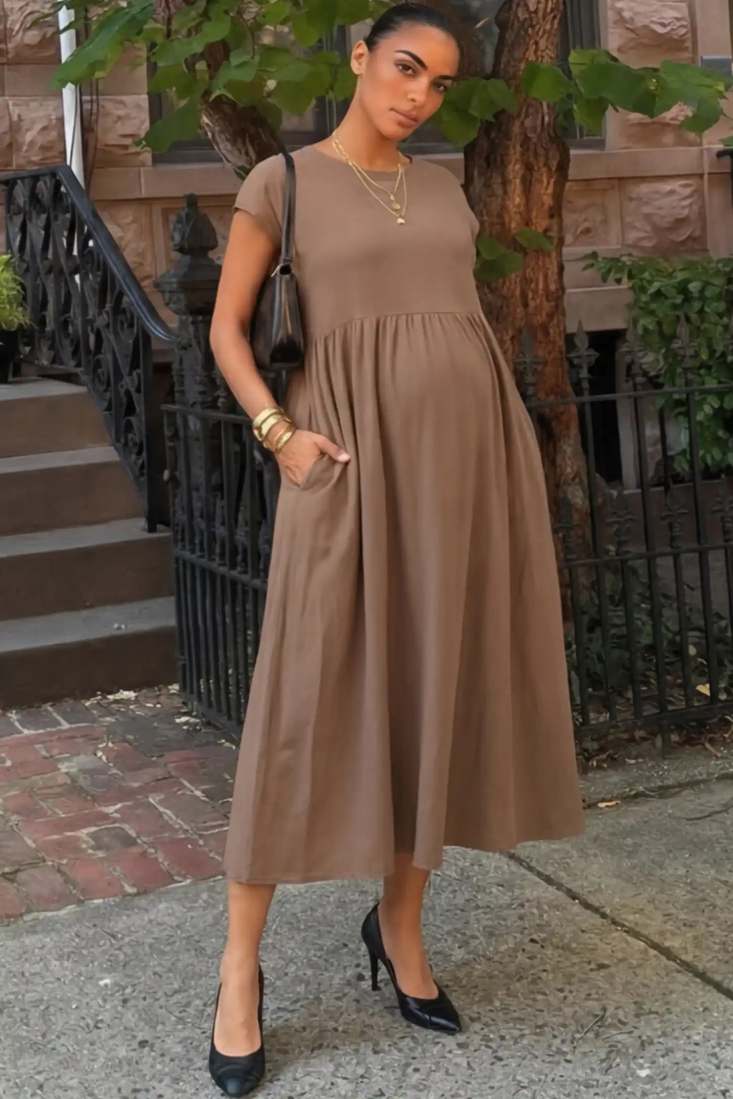 Crew Neck Short Sleeve Maternity Midi Dress Crew Neck Short Sleeve Maternity Midi Dress in Khaki featuring a flowy shift silhouette on a pregnant woman, front view.