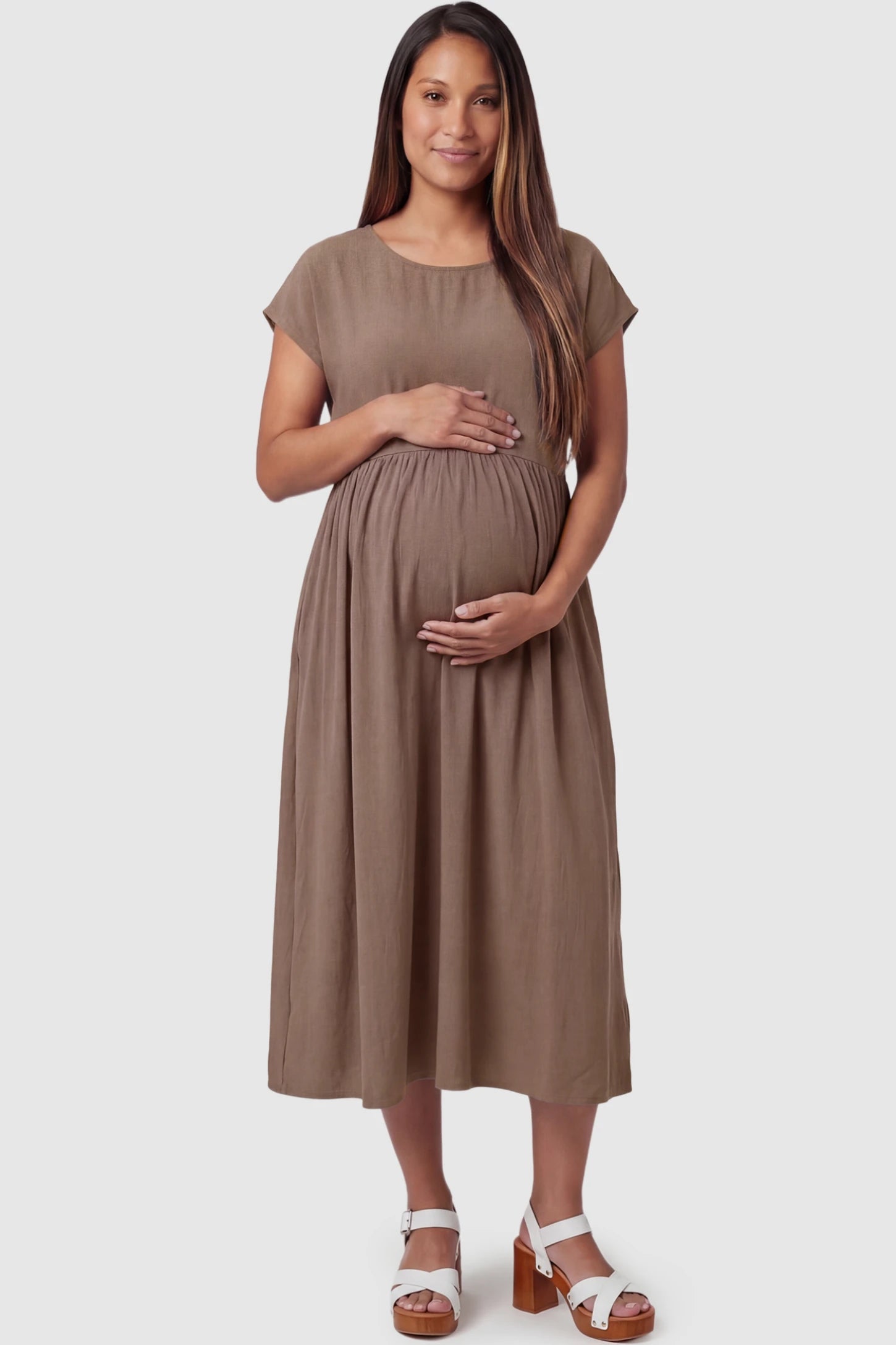 Crew Neck Short Sleeve Maternity Midi Dress Crew Neck Short Sleeve Maternity Midi Dress in Khaki featuring a flowy shift silhouette on a pregnant model, front view.
