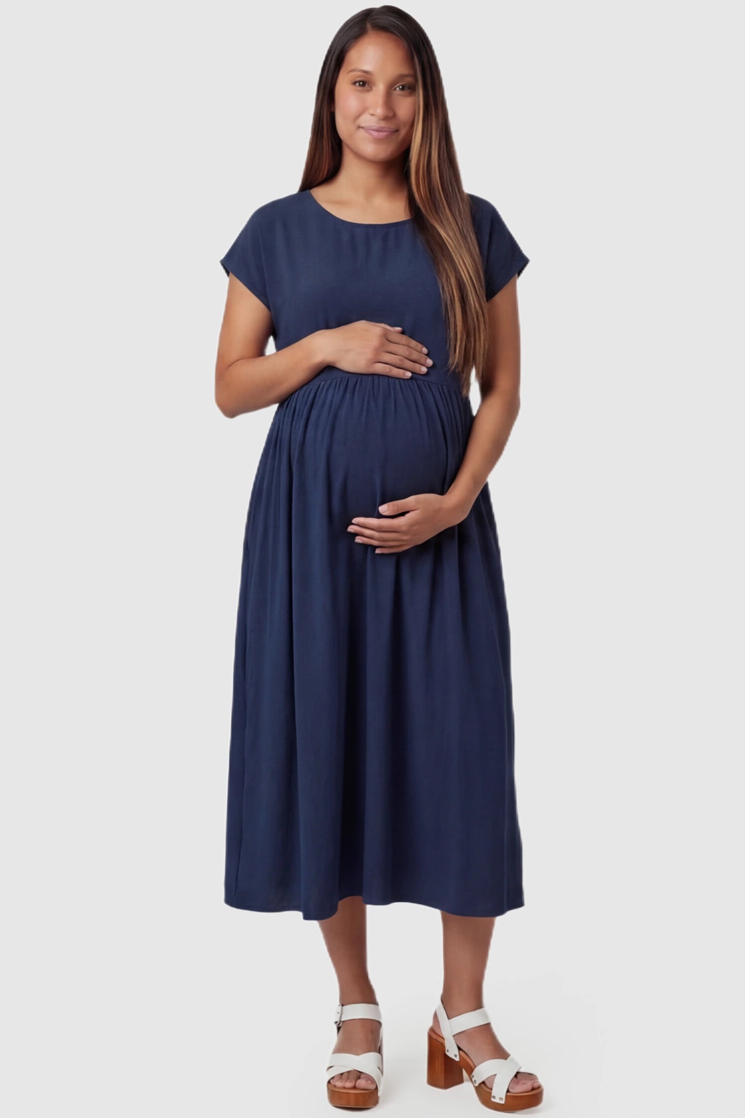 Crew Neck Short Sleeve Maternity Midi Dress in Navy blue featuring a flowy shift silhouette on a pregnant model, front view.