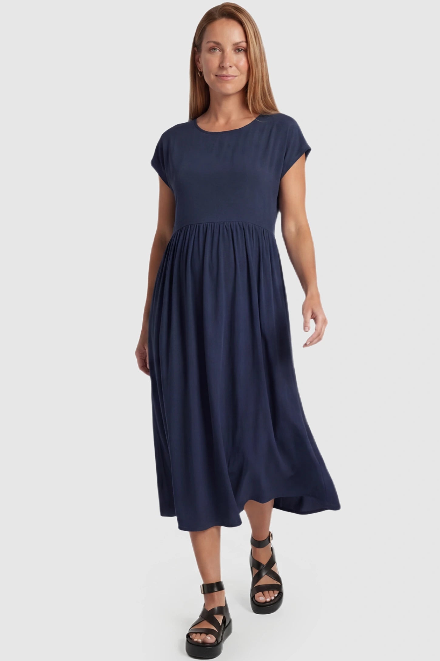 Crew Neck Short Sleeve Maternity Midi Dress Crew Neck Short Sleeve Maternity Midi Dress in Navy blue featuring a flowy shift silhouette on a postpartum model, front view.