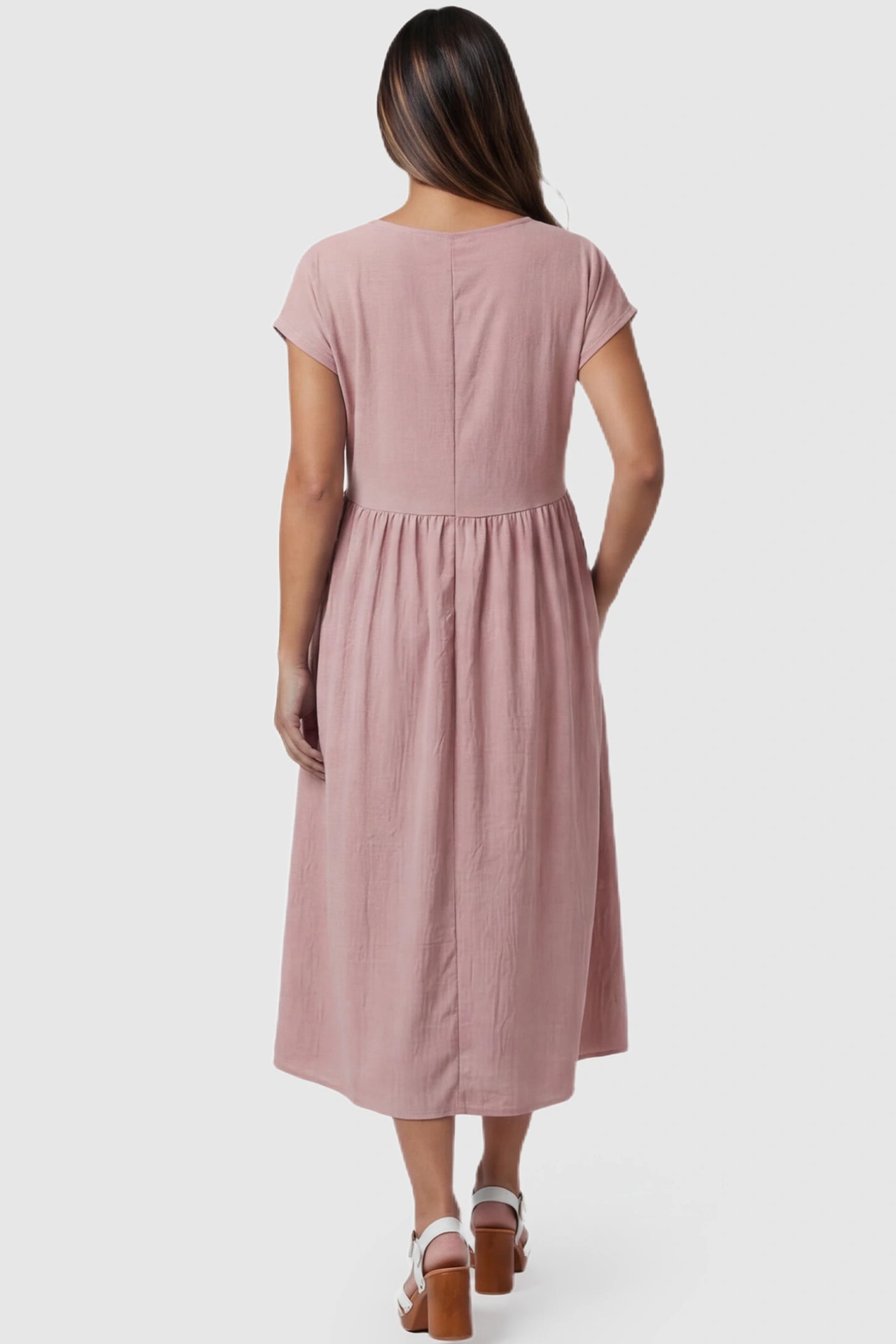 Crew Neck Short Sleeve Maternity Midi Dress Crew Neck Short Sleeve Maternity Midi Dress in Pink featuring a flowy shift silhouette on a pregnant model, back view.