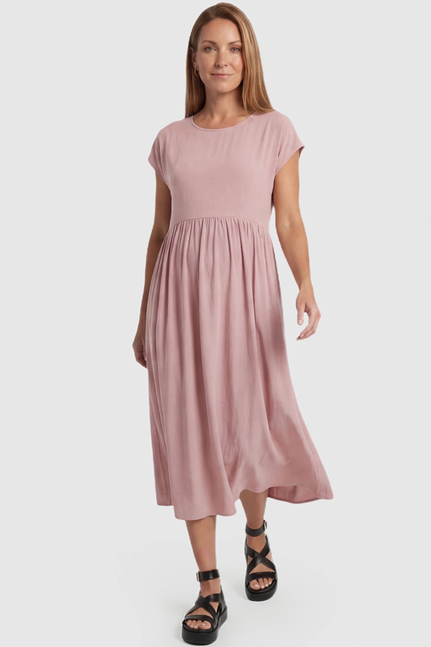 Crew Neck Short Sleeve Maternity Midi Dress Crew Neck Short Sleeve Maternity Midi Dress in Pink featuring a flowy shift silhouette on a postpartum model, front view.