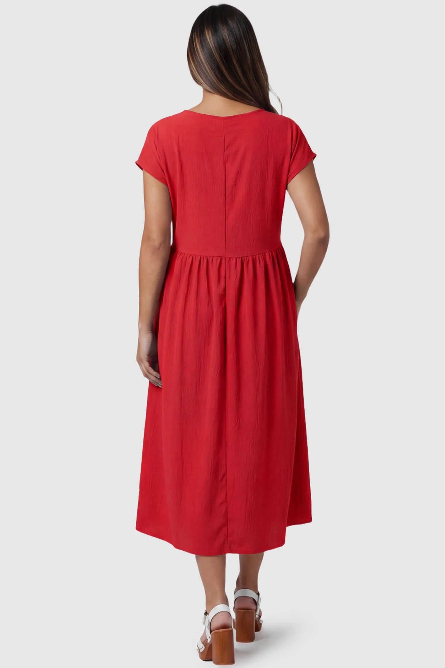 Crew Neck Short Sleeve Maternity Midi Dress Crew Neck Short Sleeve Maternity Midi Dress in Red featuring a flowy shift silhouette on a pregnant model, back view.