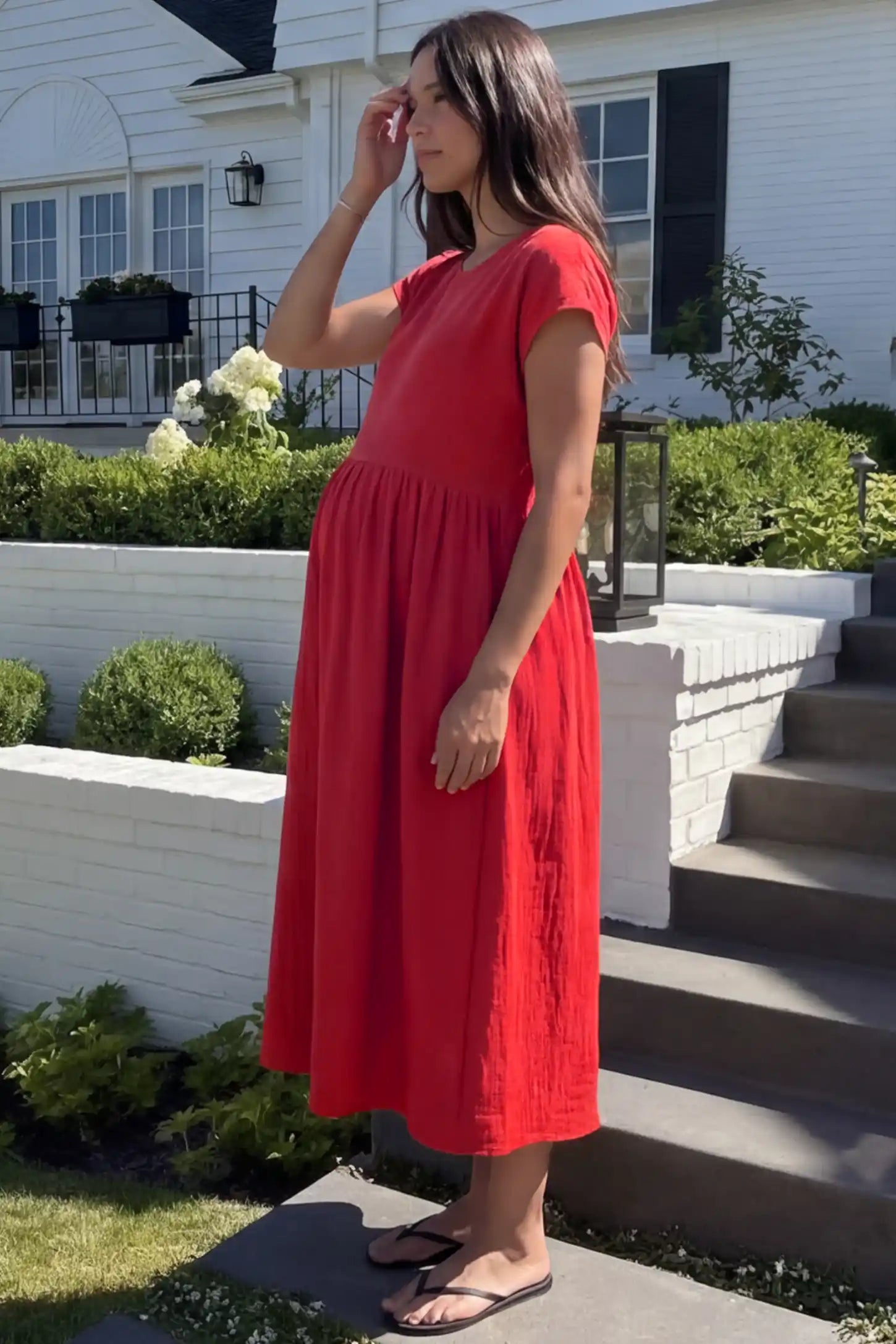 Crew Neck Short Sleeve Maternity Midi Dress Crew Neck Short Sleeve Maternity Midi Dress in Red featuring a flowy shift silhouette on a pregnant woman, side view.