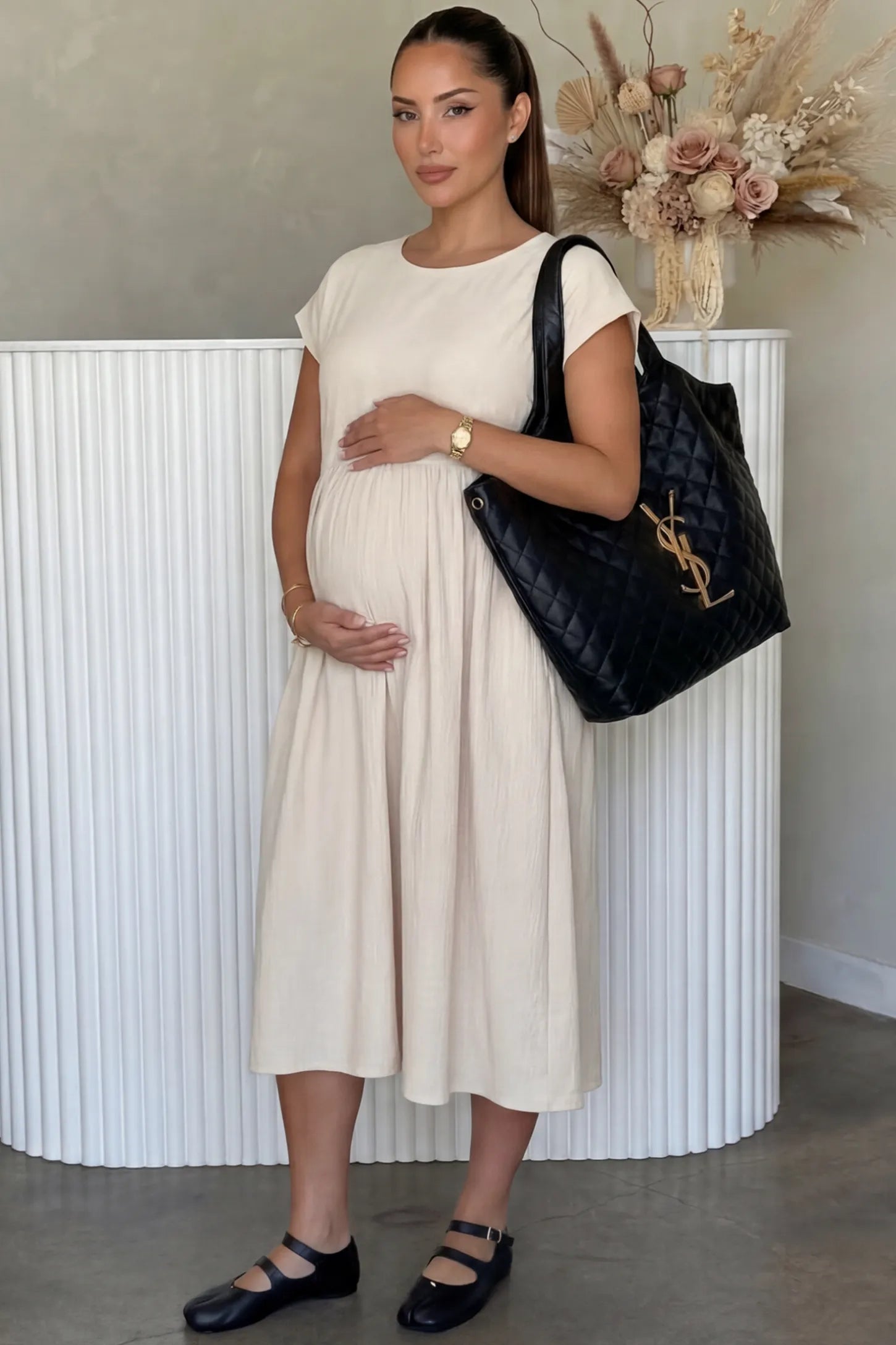Crew Neck Short Sleeve Maternity Midi Dress Crew Neck Short Sleeve Maternity Midi Dress in White featuring a flowy shift silhouette on a pregnant woman, front view.