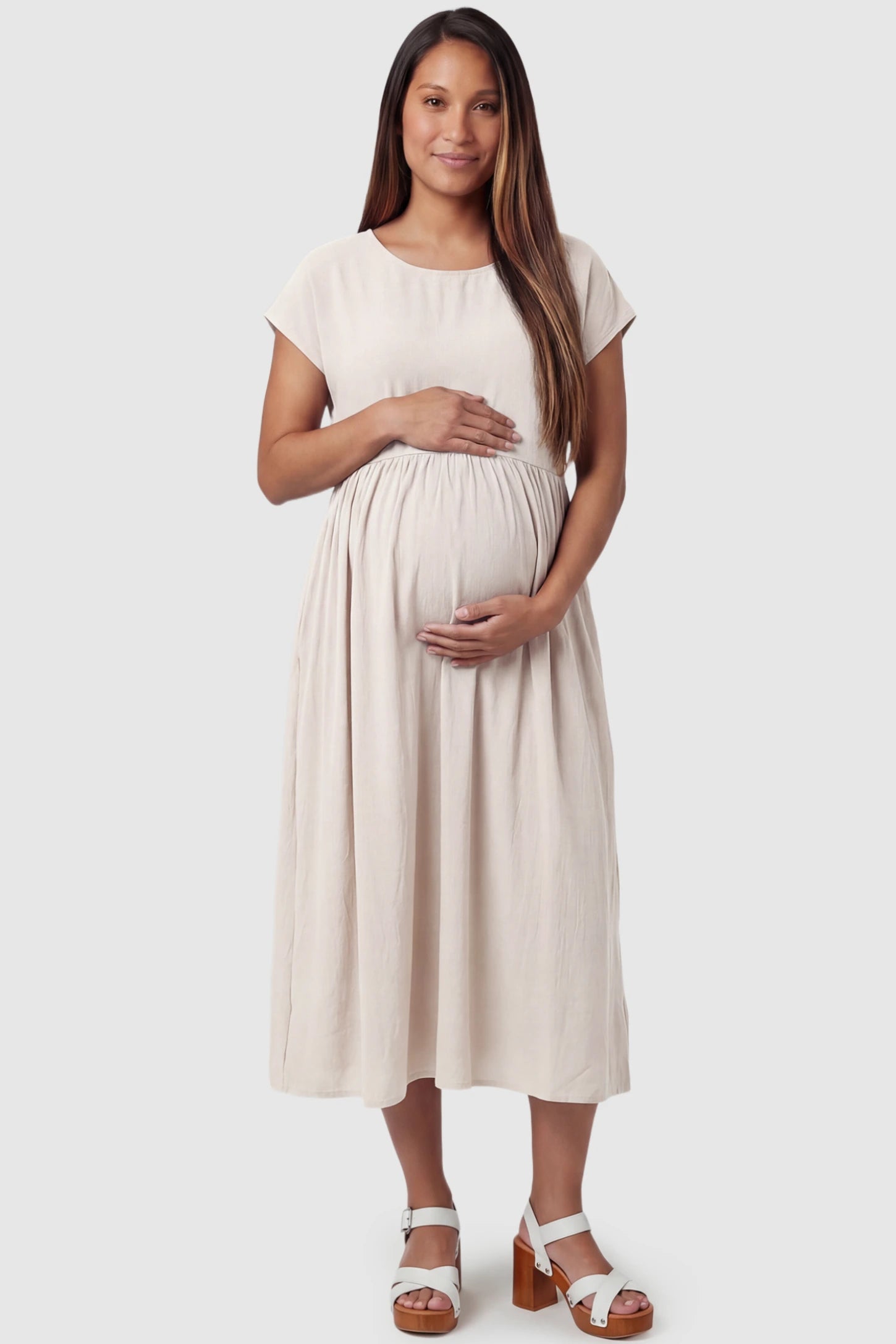 Crew Neck Short Sleeve Maternity Midi Dress Crew Neck Short Sleeve Maternity Midi Dress in White featuring a flowy shift silhouette on a pregnant model, front view.