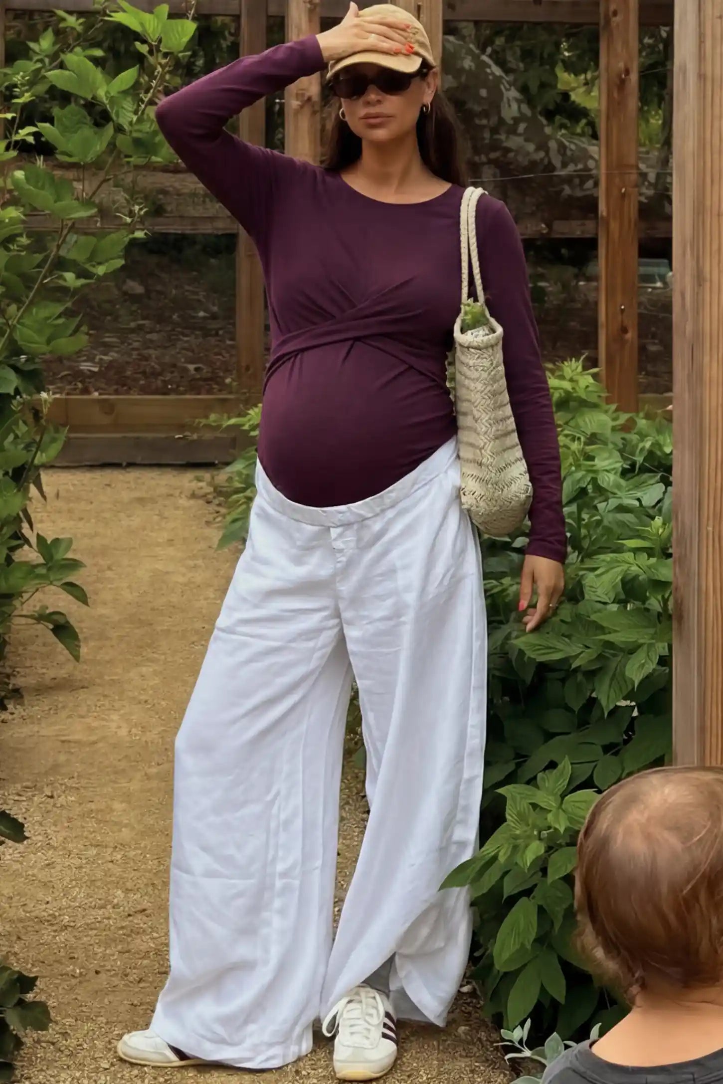 Cross Front Long Sleeve Maternity Top Cross Front Long Sleeve Maternity Top in Dark Purple featuring a crossover waist detail on a pregnant woman.