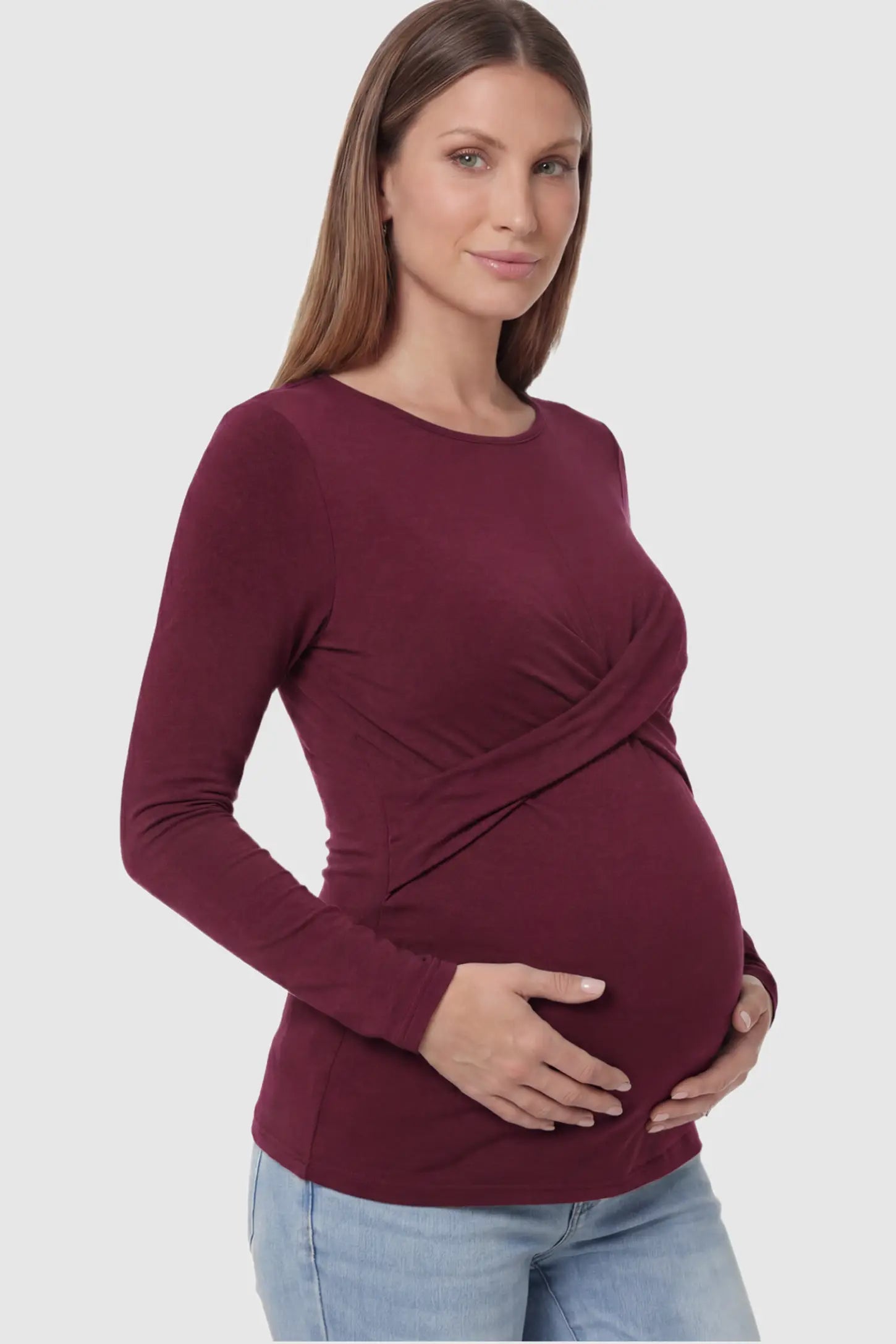 Cross Front Long Sleeve Maternity Top in Dark Purple featuring a crossover waist detail on a pregnant model showing side.