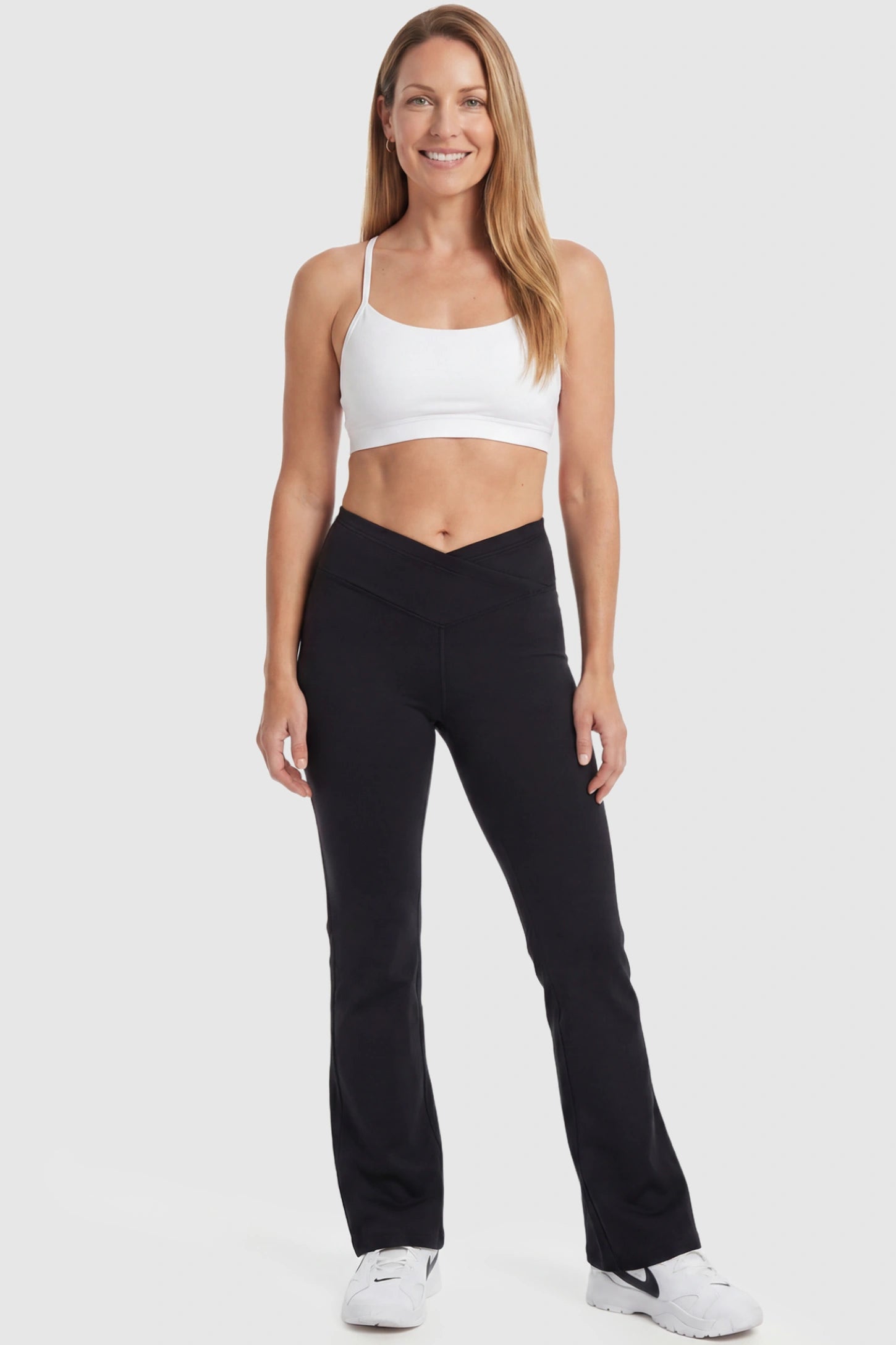 Crossover Waistline Flared Maternity Pants Crossover Waistline Flared Maternity Pants in Black featuring a V-shaped band on a postpartum model, front view.