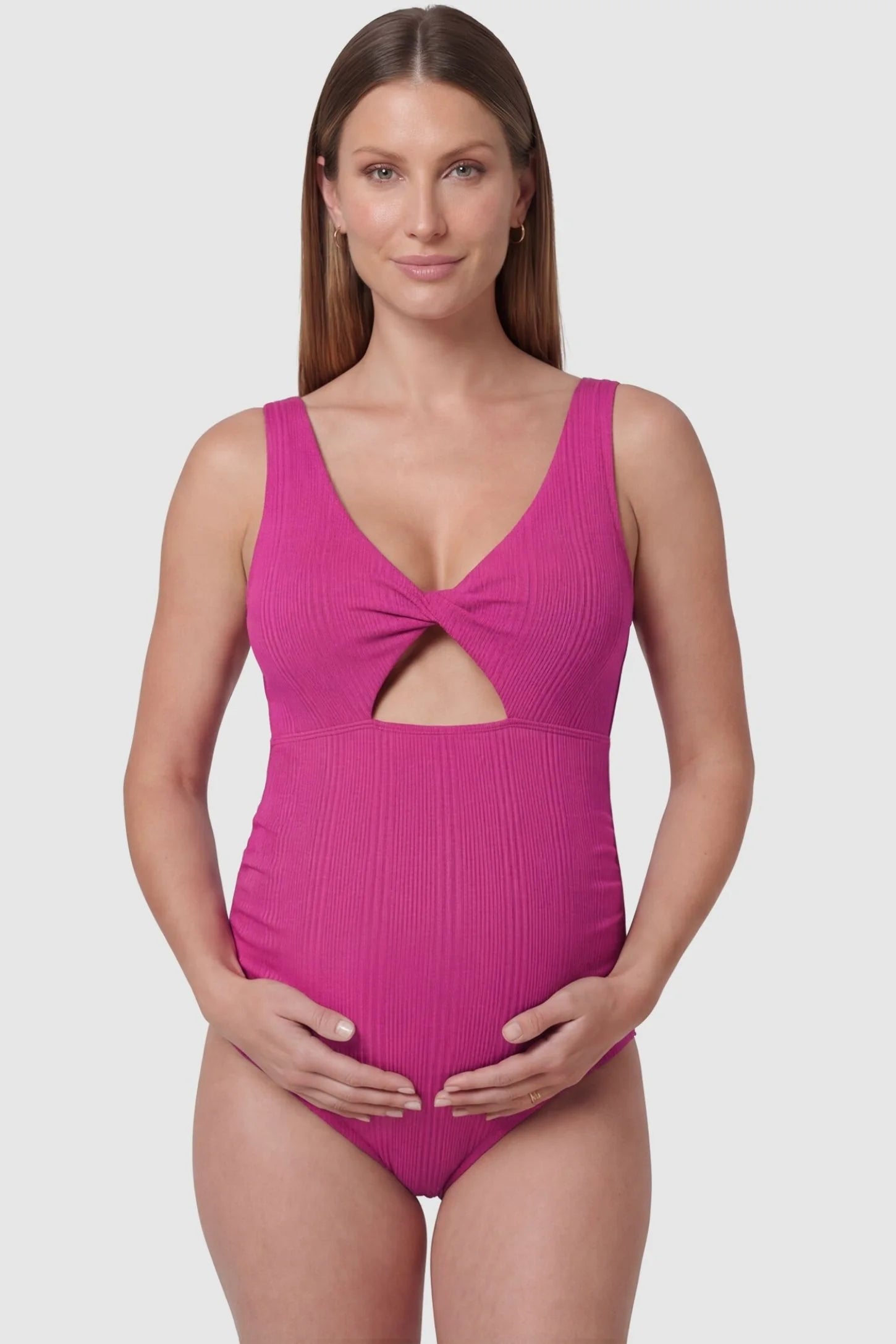 Cutout Twisted V-Neck Maternity Swimsuit Cutout Twisted V-Neck Maternity Swimsuit in Fuchsia featuring a front view with a knotted bust on a pregnant model.