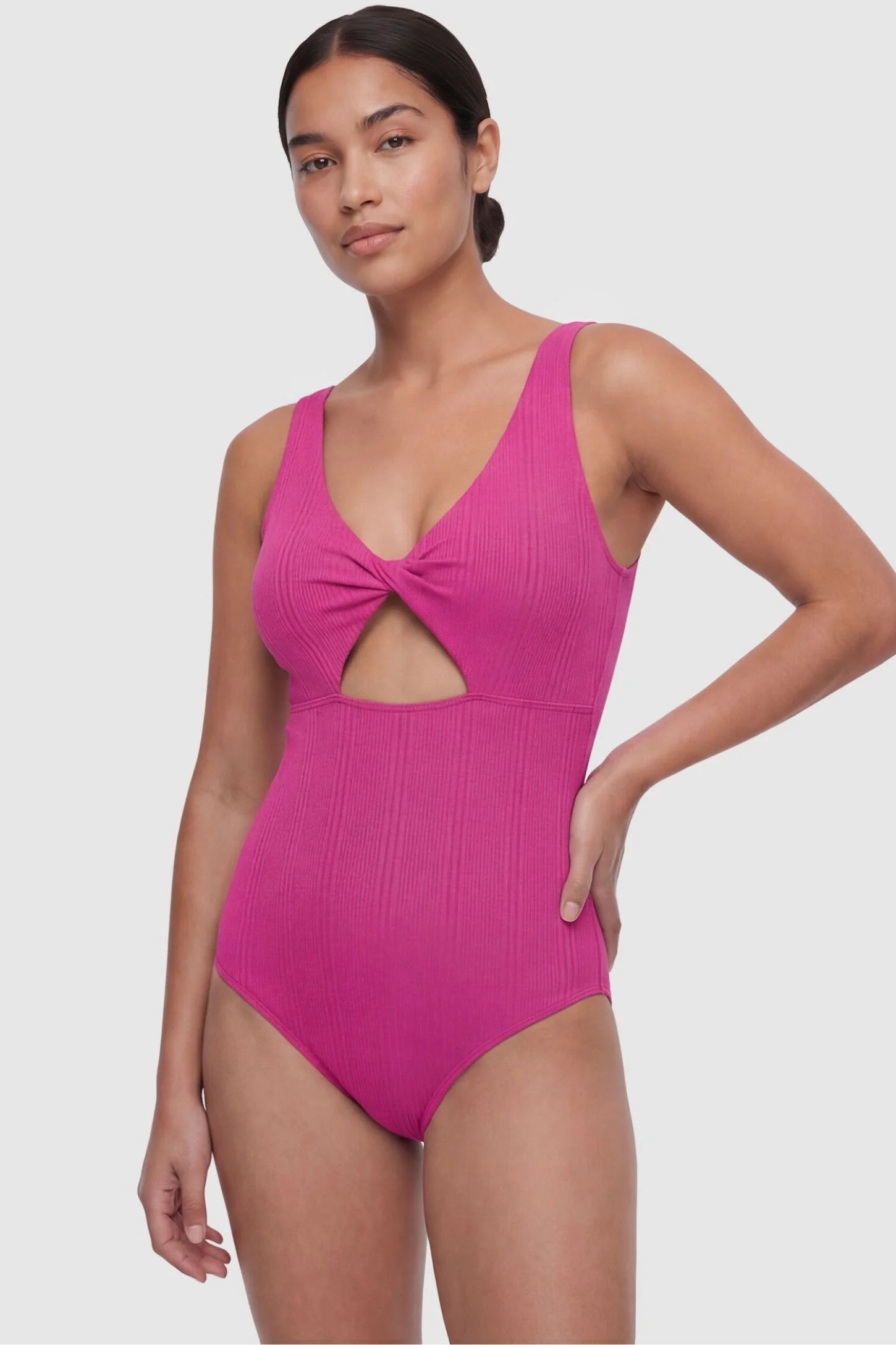 Cutout Twisted V-Neck Maternity Swimsuit Cutout Twisted V-Neck Maternity Swimsuit in Fuchsia featuring a front view on a non-pregnant postpartum model.