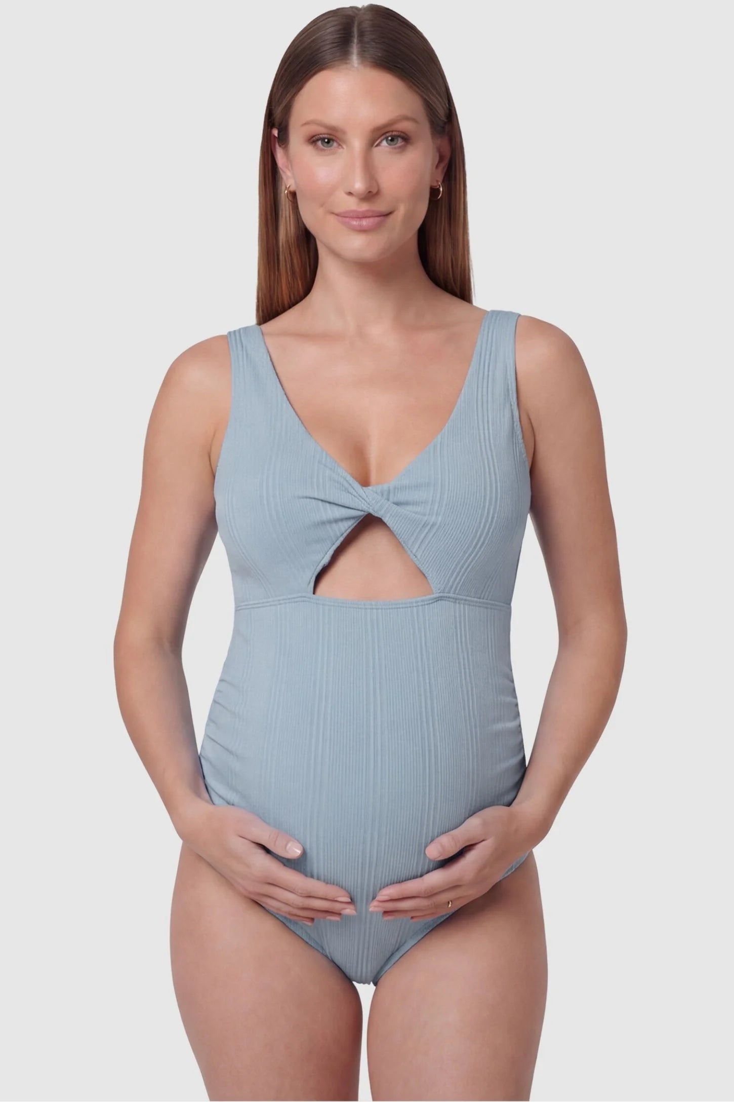 Cutout Twisted V-Neck Maternity Swimsuit Cutout Twisted V-Neck Maternity Swimsuit in Light Blue featuring a front view with a knotted bust on a pregnant model.