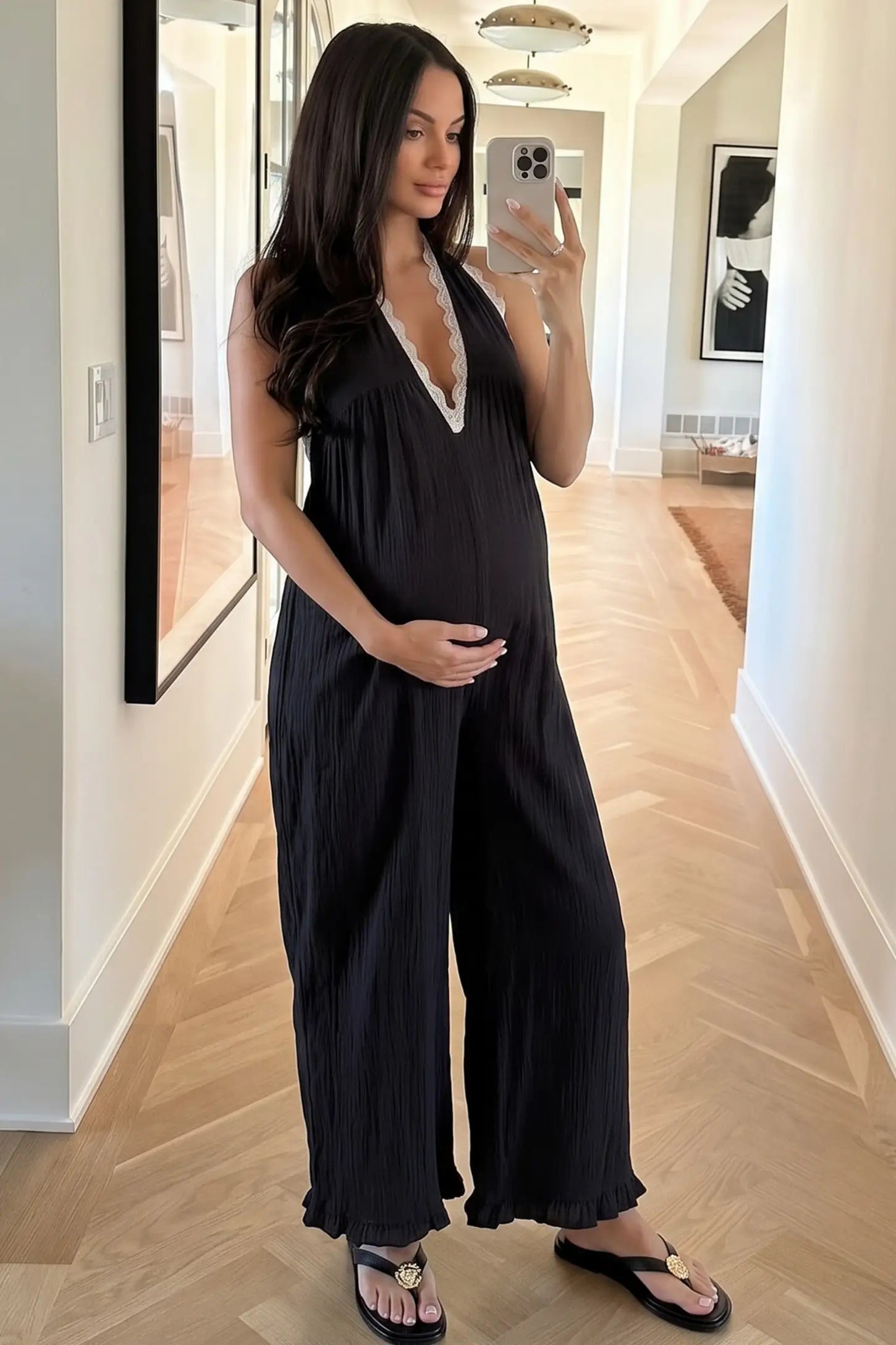 Deep V-Neck Lace Trim Wide Leg Maternity Jumpsuit Deep V-Neck Lace Trim Wide Leg Maternity Jumpsuit in Black featuring a relaxed wide leg fit with lace trim neckline in a user lifestyle setting, pregnant model.
