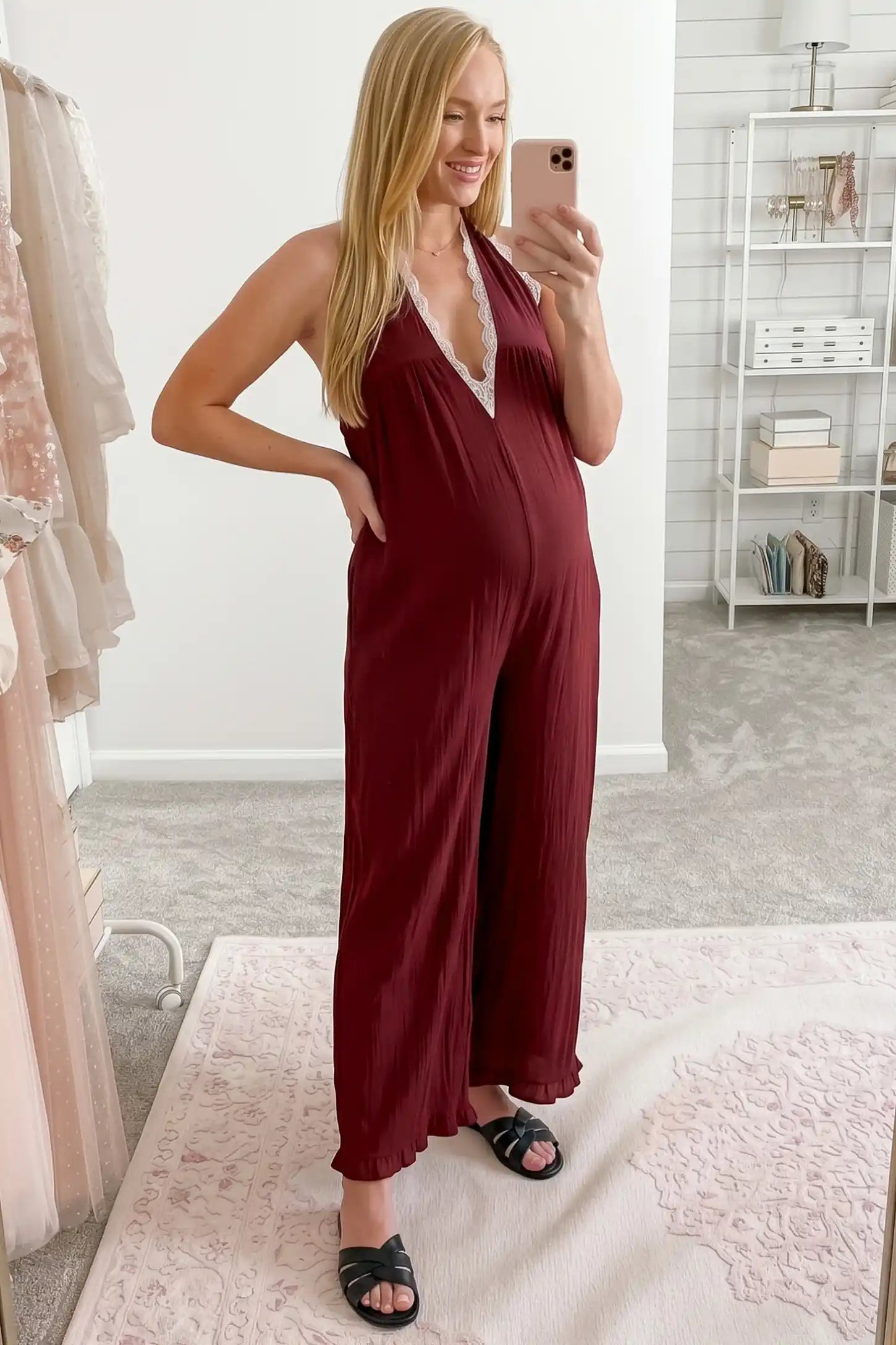 Deep V-Neck Lace Trim Wide Leg Maternity Jumpsuit Deep V-Neck Lace Trim Wide Leg Maternity Jumpsuit in Burgundy featuring a relaxed wide leg fit with lace trim neckline in a user lifestyle setting, pregnant model.