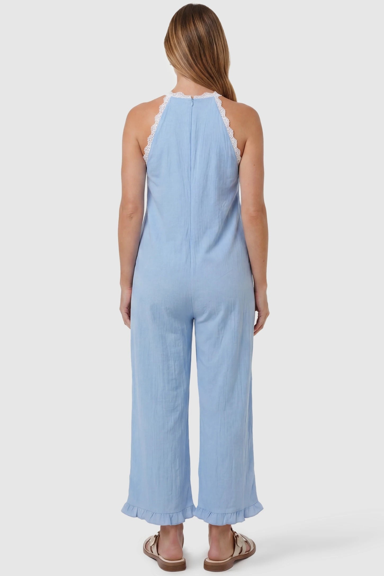 Deep V-Neck Lace Trim Wide Leg Maternity Jumpsuit Deep V-Neck Lace Trim Wide Leg Maternity Jumpsuit in Light Blue featuring a lace-trimmed open back on a pregnant model, back view.
