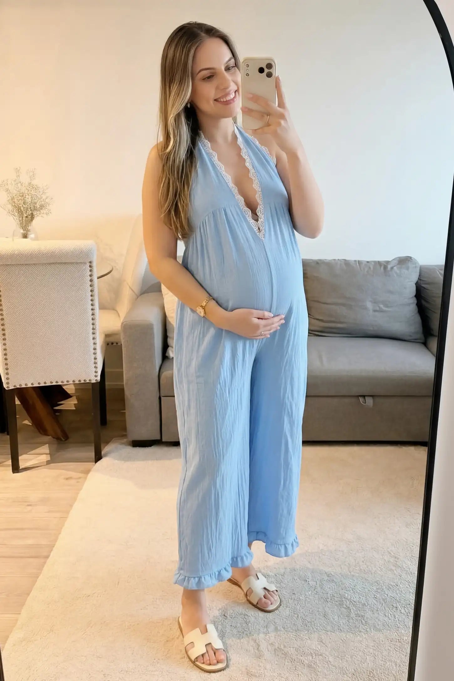 Deep V-Neck Lace Trim Wide Leg Maternity Jumpsuit Deep V-Neck Lace Trim Wide Leg Maternity Jumpsuit in Light Blue featuring a deep V neckline with lace trim on a pregnant model, mirror selfie view.