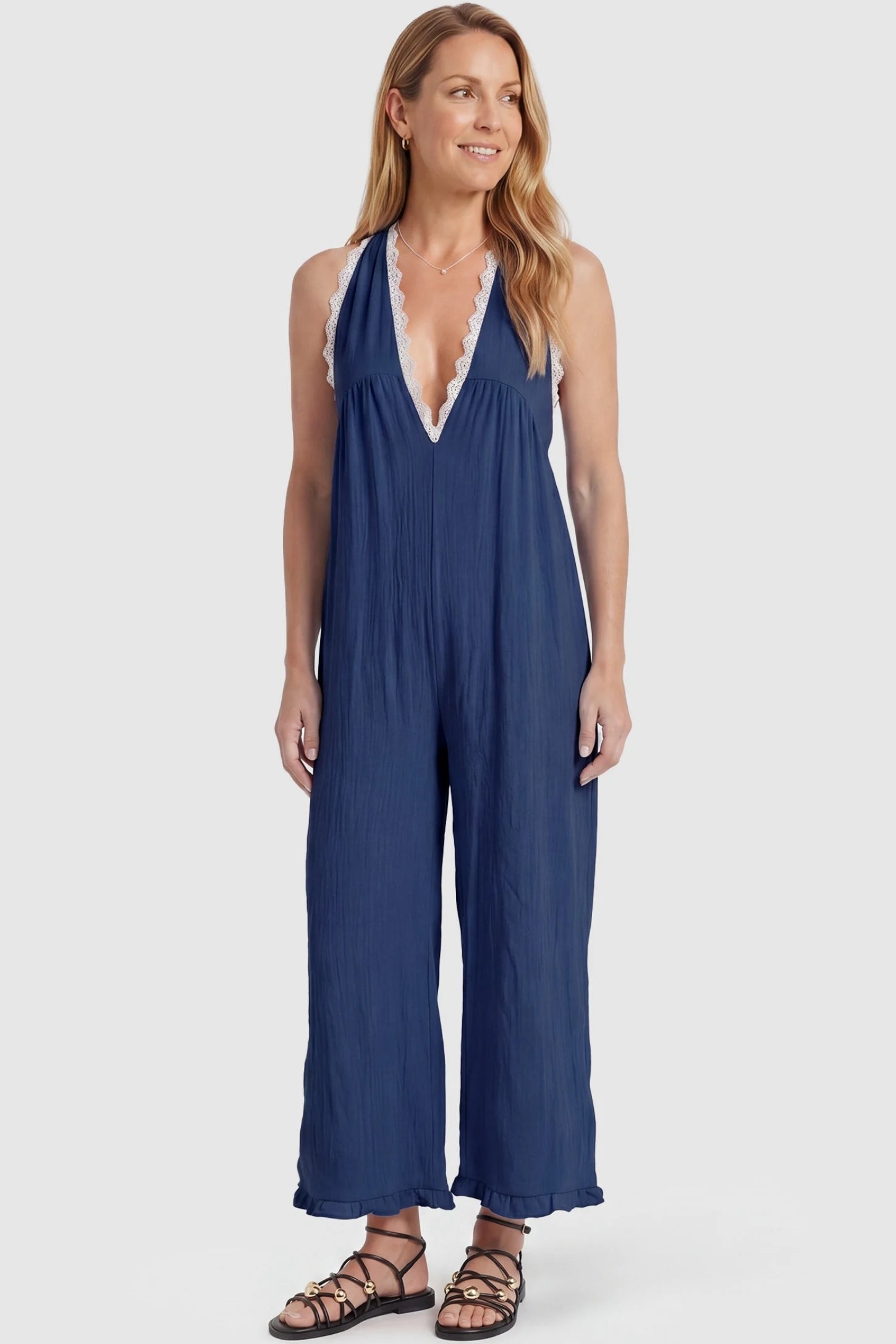 Deep V-Neck Lace Trim Wide Leg Maternity Jumpsuit Deep V-Neck Lace Trim Wide Leg Maternity Jumpsuit in Navy Blue featuring a flattering wide leg cut with lace trim neckline on a postpartum model, front view.