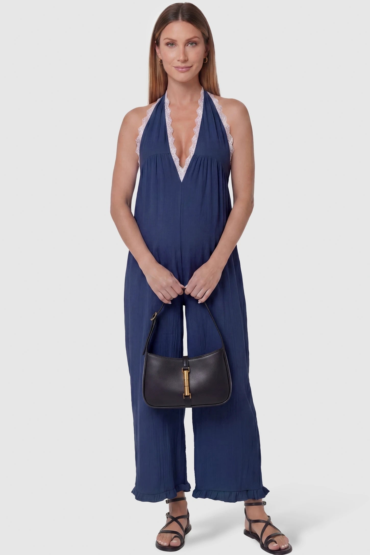 Deep V-Neck Lace Trim Wide Leg Maternity Jumpsuit Deep V-Neck Lace Trim Wide Leg Maternity Jumpsuit in Navy Blue featuring a deep V-neckline with delicate lace trim on a pregnant model, front view.