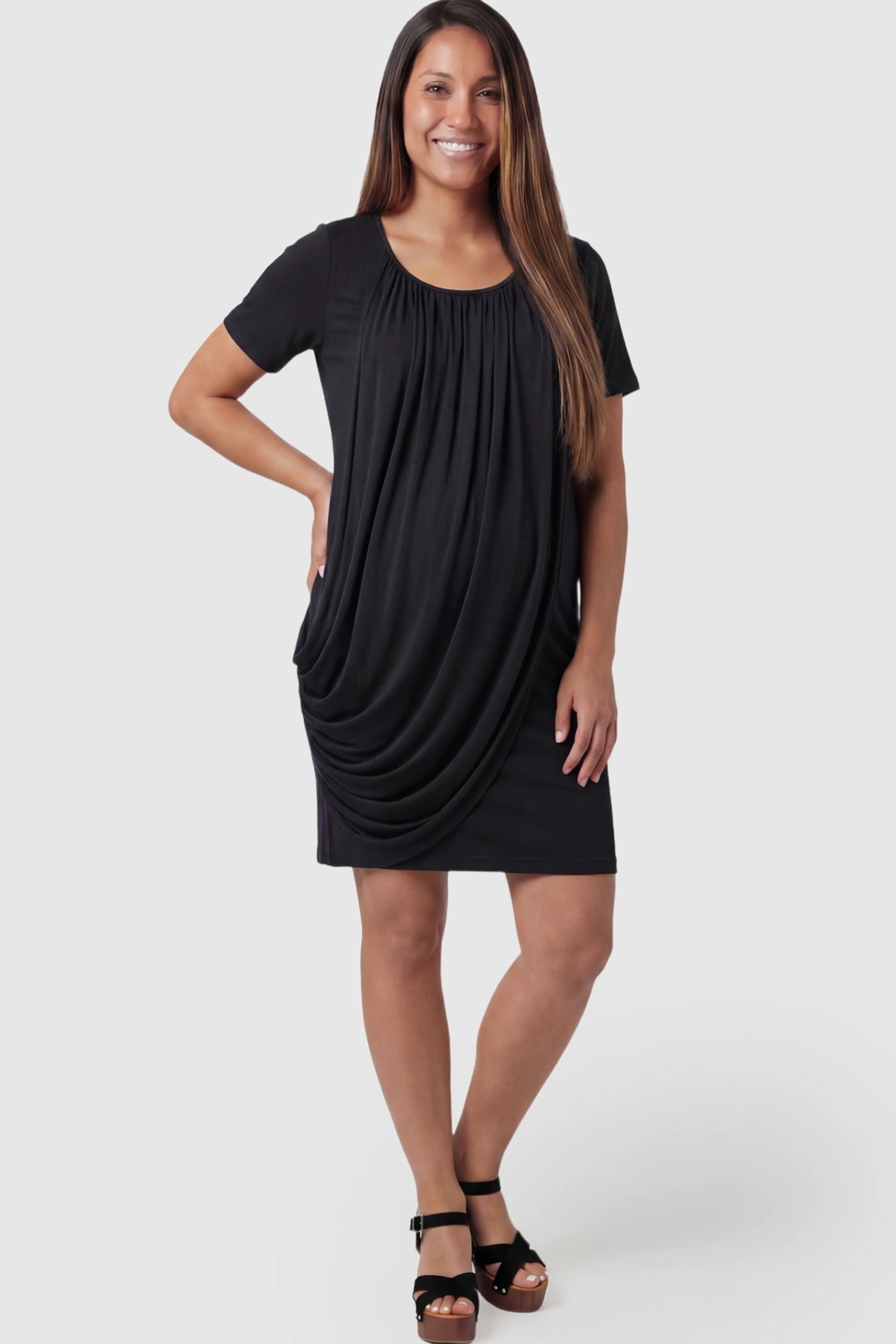 Draped Ruched Wrap Front Maternity Nursing Dress in Black with short sleeves on a pregnant model posing front.