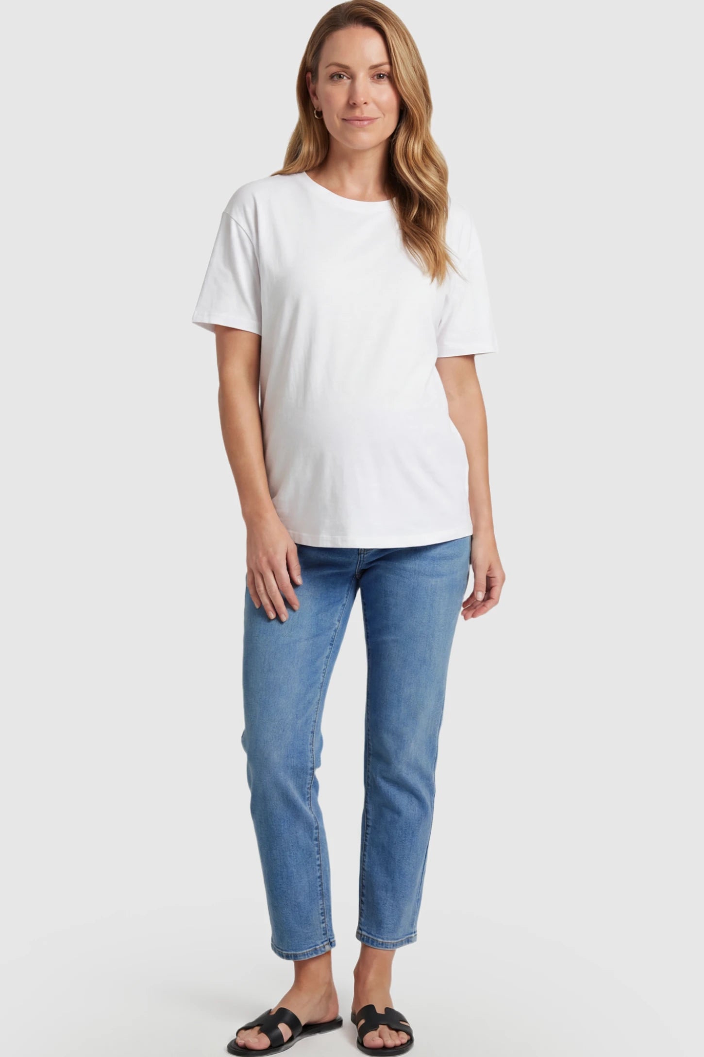Elastic Full Panel Straight Leg Maternity Jeans Elastic Full Panel Straight Leg Maternity Jeans in Denim Blue featuring a high-stretch jersey waistband on a pregnant model facing front.