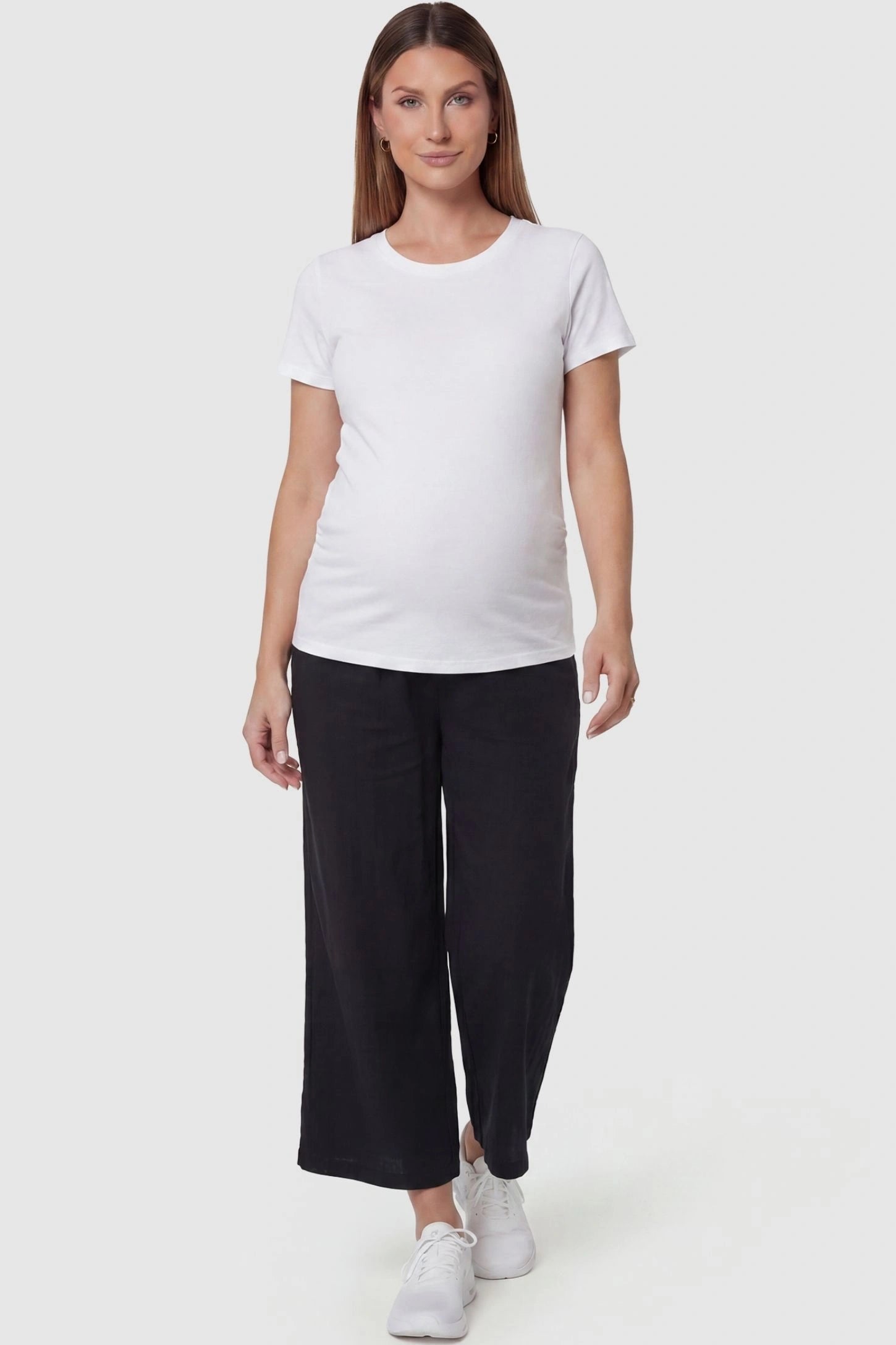 Elastic High Waisted Cropped Maternity Pants in Black featuring a cropped pants on a pregnant model, front view.