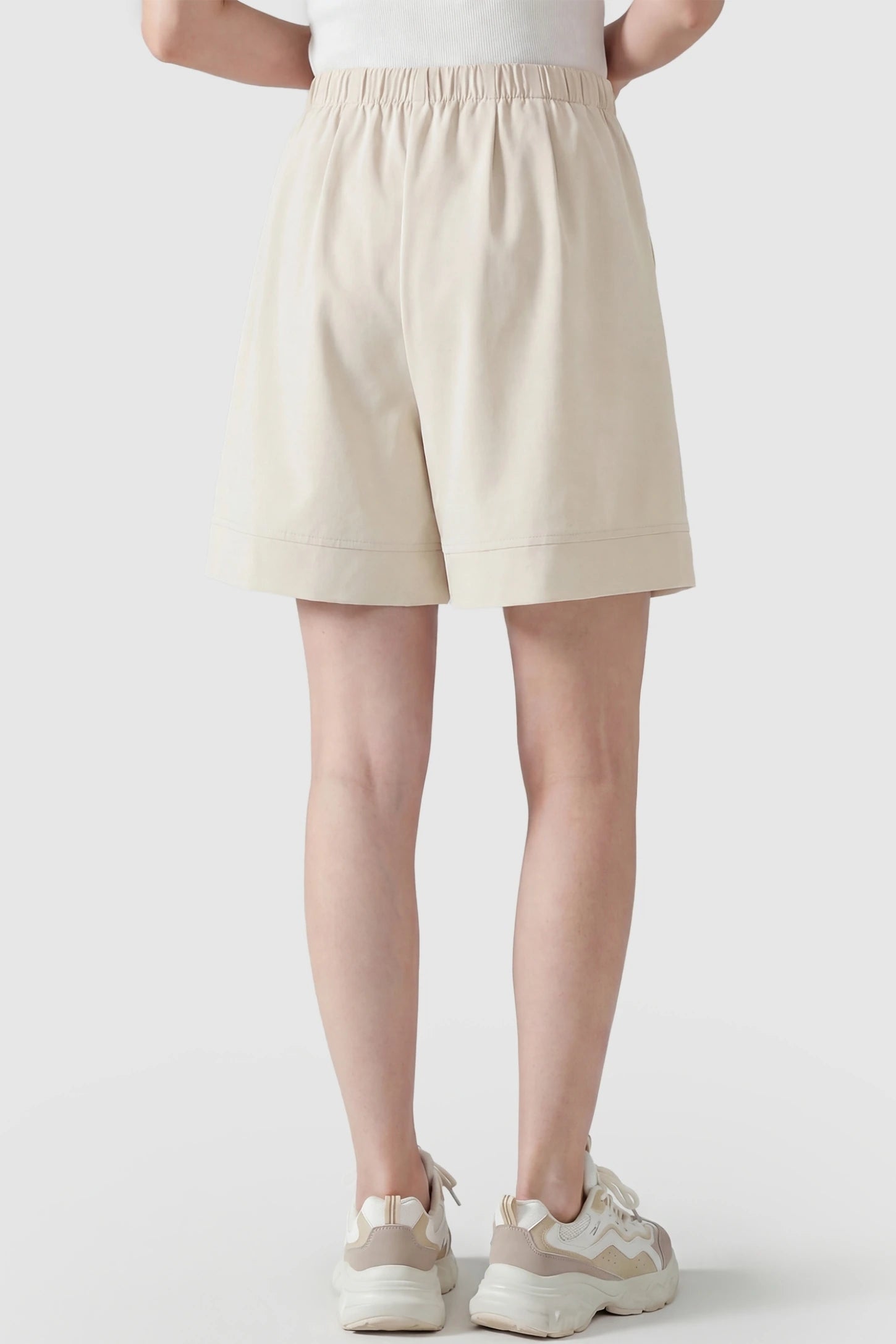 Pocketed Side Drawstring Maternity Shorts Back view of Beige Wide Leg Lounge Shorts featuring a relaxed fit on a postpartum model for everyday comfort.